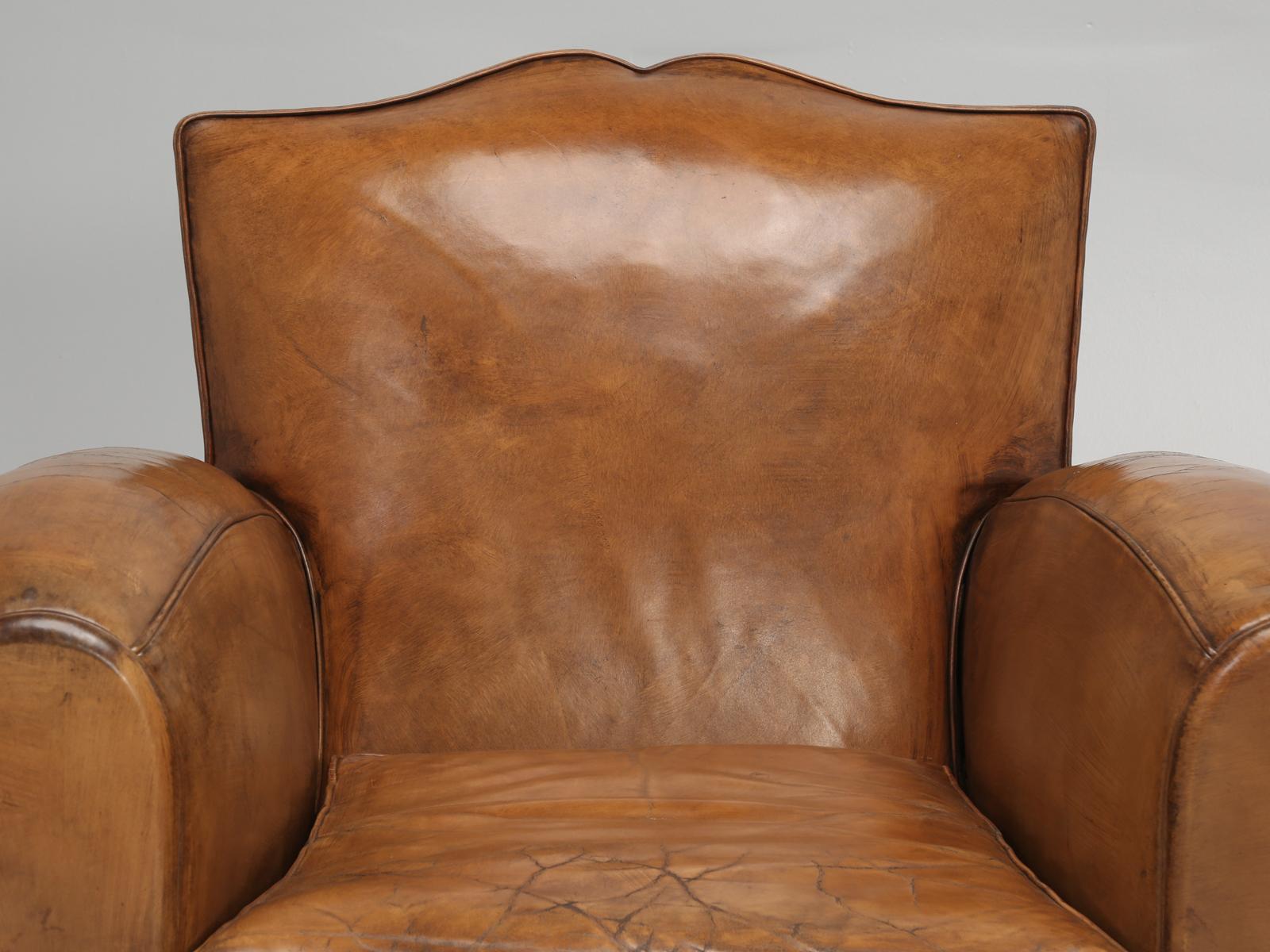 Authentic Mustache back French leather club chairs from the Art Deco period. Our Old Plank upholstery department, has painstakingly rebuilt the club chairs from the bare wooden frame. This means essentially you will have an 85-year old pair of