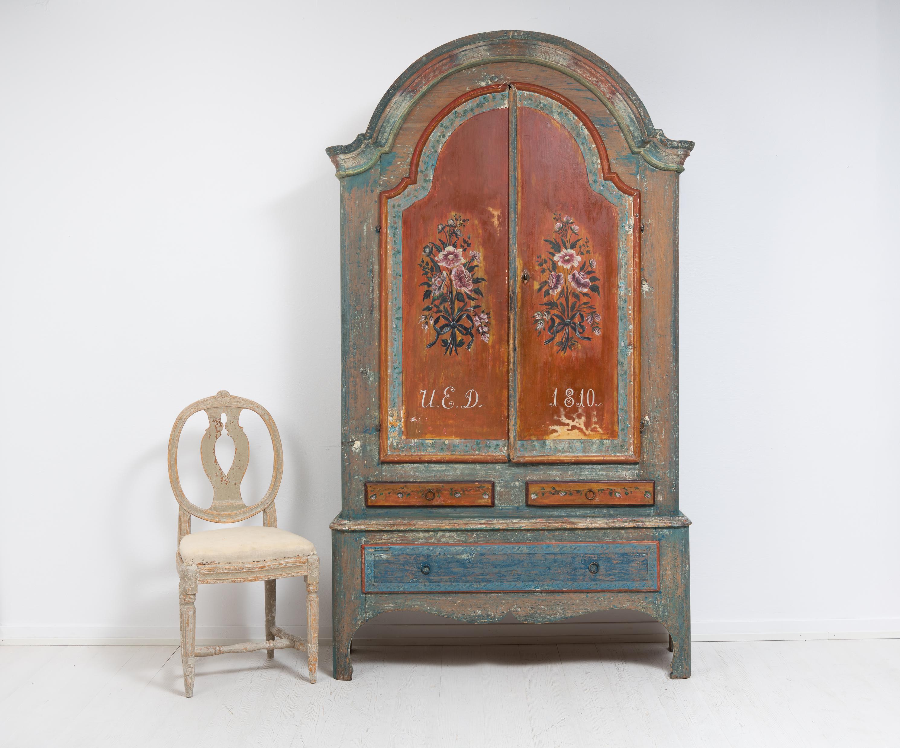 Folk art rococo cabinet from northern Sweden made in painted pine. The cabinet has the original paint and dating from 1810. Because it is a furniture with old original paint there are some marks and traces of distress after use.

The cabinet was