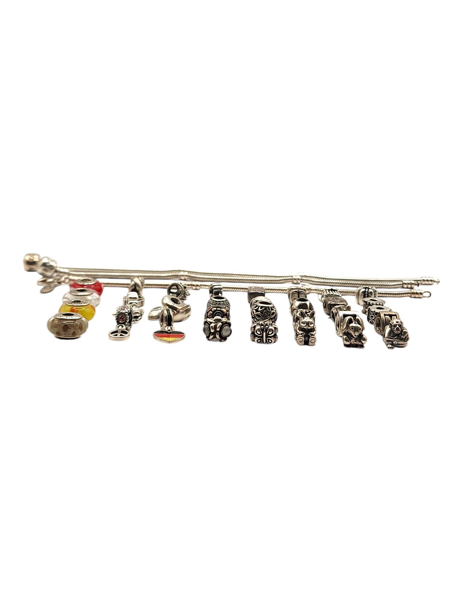 Authentic Pandora Lot of 35 Sterling Silver Charms & Bracelets

Lot features 32 sterling silver authentic Pandora charms, including dangle charms, cz charms, murano beads, clips and more!
3 Pandora snake chain bracelets
7.5