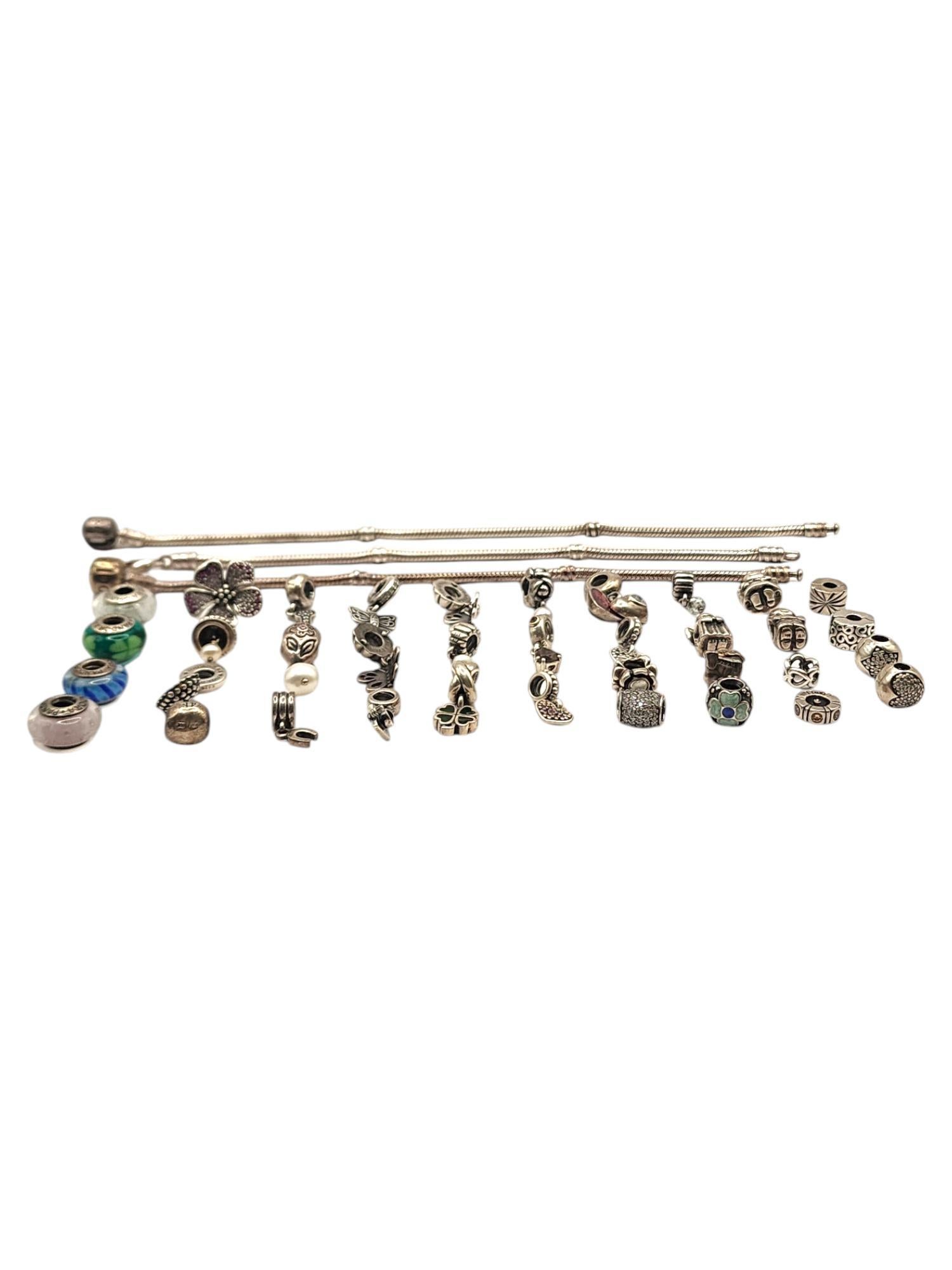 Authentic Pandora Lot of 39 Sterling Silver Charms & Bracelets

Lot features 36 sterling silver authentic Pandora charms, including dangle charms, cz charms, murano beads, clips and more!
3 Pandora snake chain bracelets
7