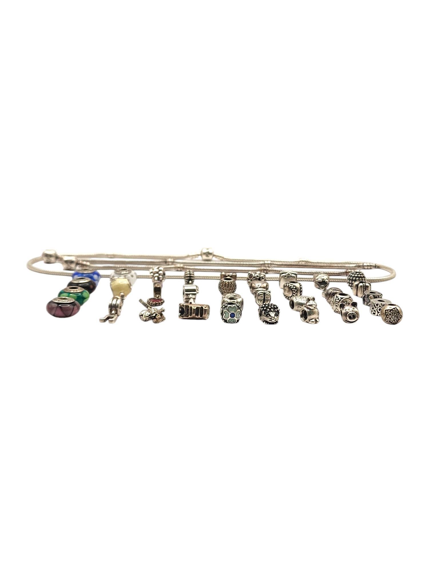 Authentic Pandora Lot of 40 Sterling Silver Charms, Bracelets & Necklace

Lot features 37 sterling silver authentic Pandora charms, including dangle charms, cz charms, murano beads, clips and more!
2 Pandora snake chain bracelets
7.25