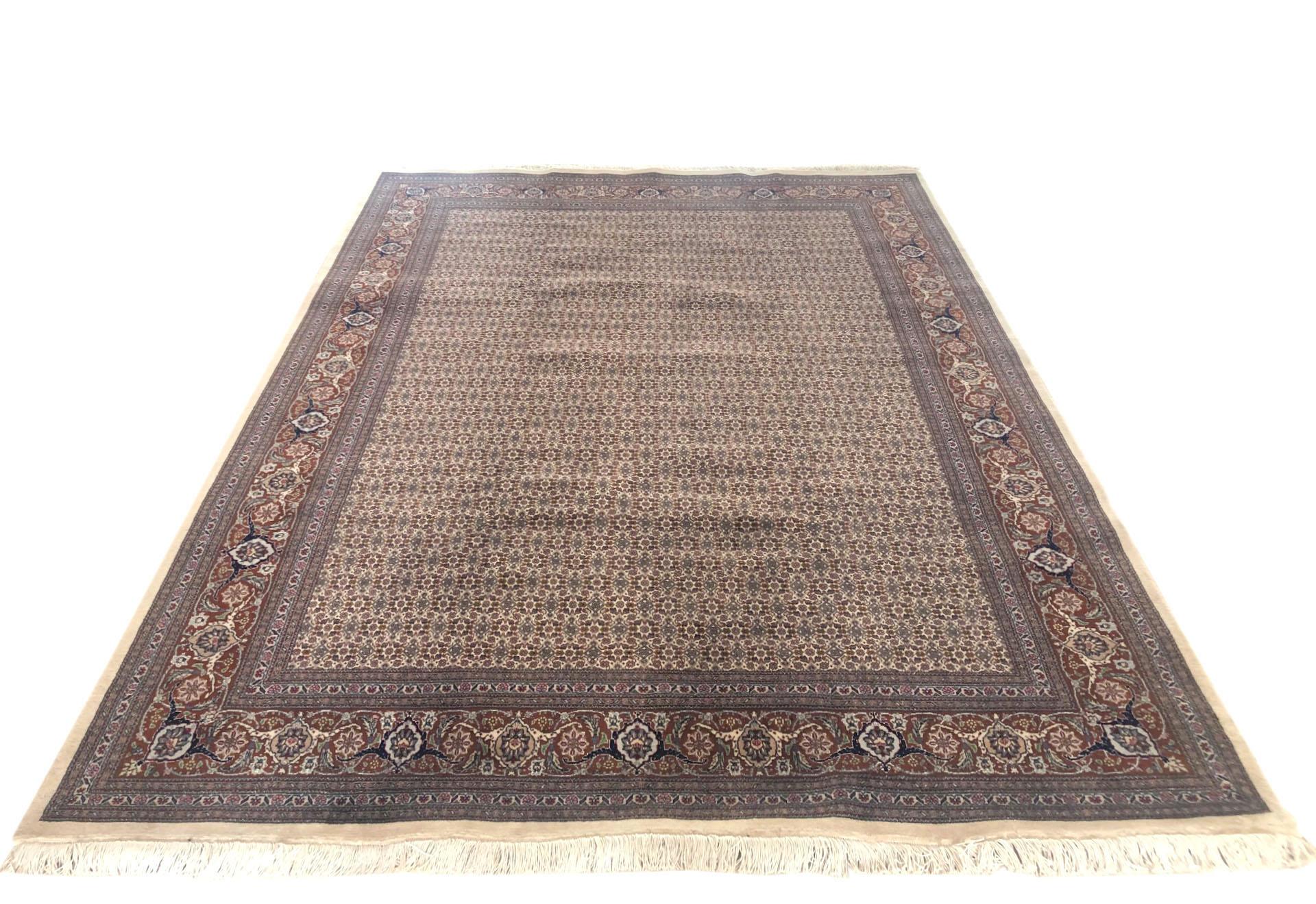 Tabriz rugs are well known for their excellent weaving and design. One of the very famous patterns of Tabriz rugs are Fish Design known is Mahi. This beautiful piece has wool and silk pile with cotton foundation. The base color is cream and the