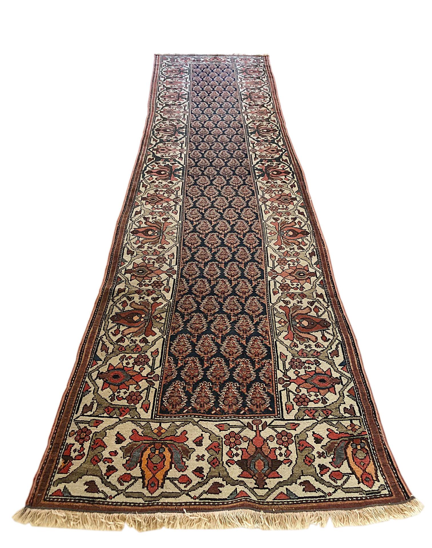 This antique rug is a Persian Bakhtiari with wool pile and wool foundation. This is a very unique piece, circa 1880s. The pile and foundation are wool. The design is all over paisley design. The base color is dark blue with cream border. The size is