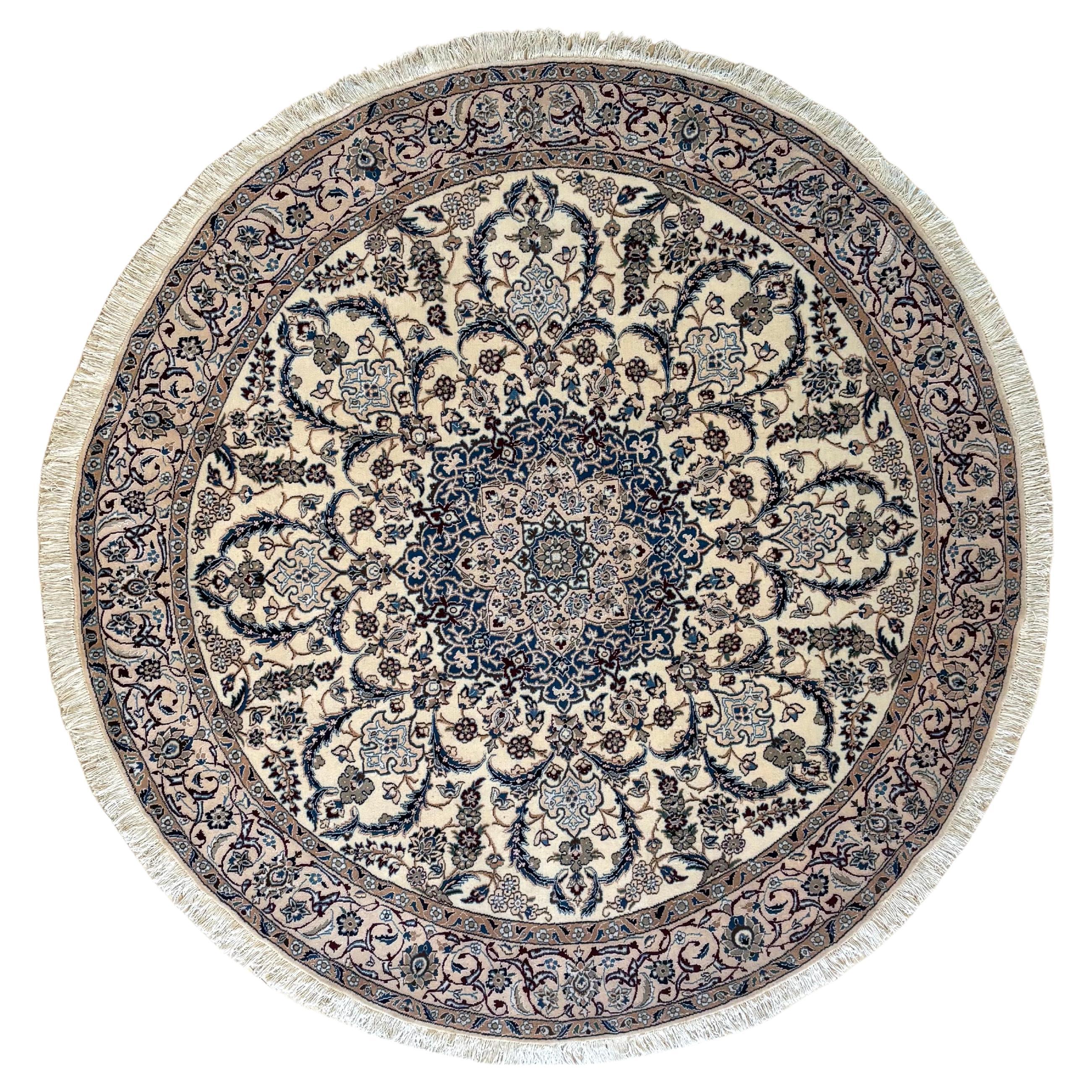This authentic Persian round hand-made Nain 9 LAA (rug has high quality wool and silk pile with cotton foundation. The silk highlights the detail in the design. Nain is a city in Iran that is well known for producing fine handmade rug. This rug has