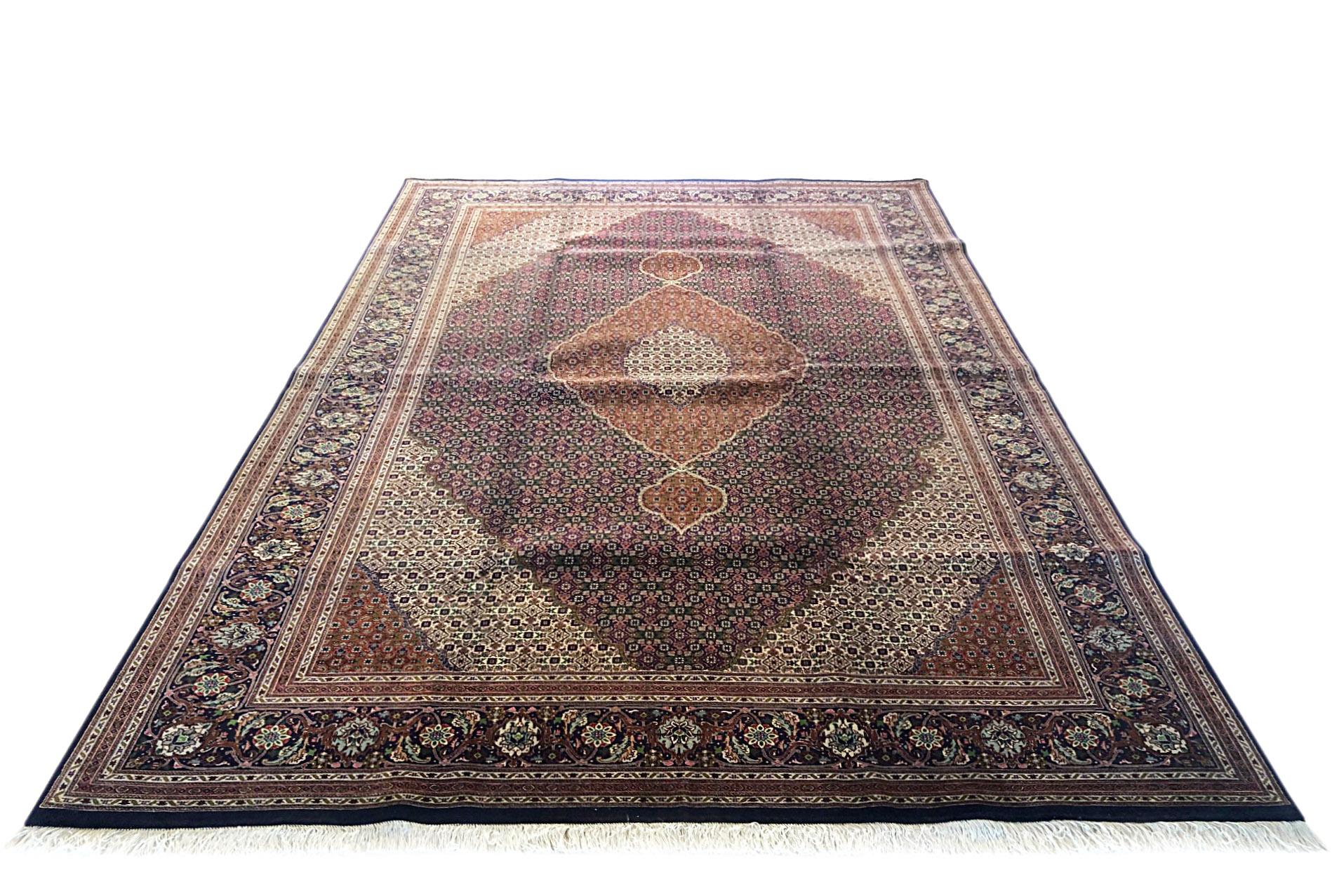 Tabriz rugs are well known for their excellent weaving and design. One of the very famous patterns of Tabriz rugs are fish design known is Mahi. This beautiful piece has wool and silk pile with cotton foundation. This is an 1970s 50 “Raj” consistent