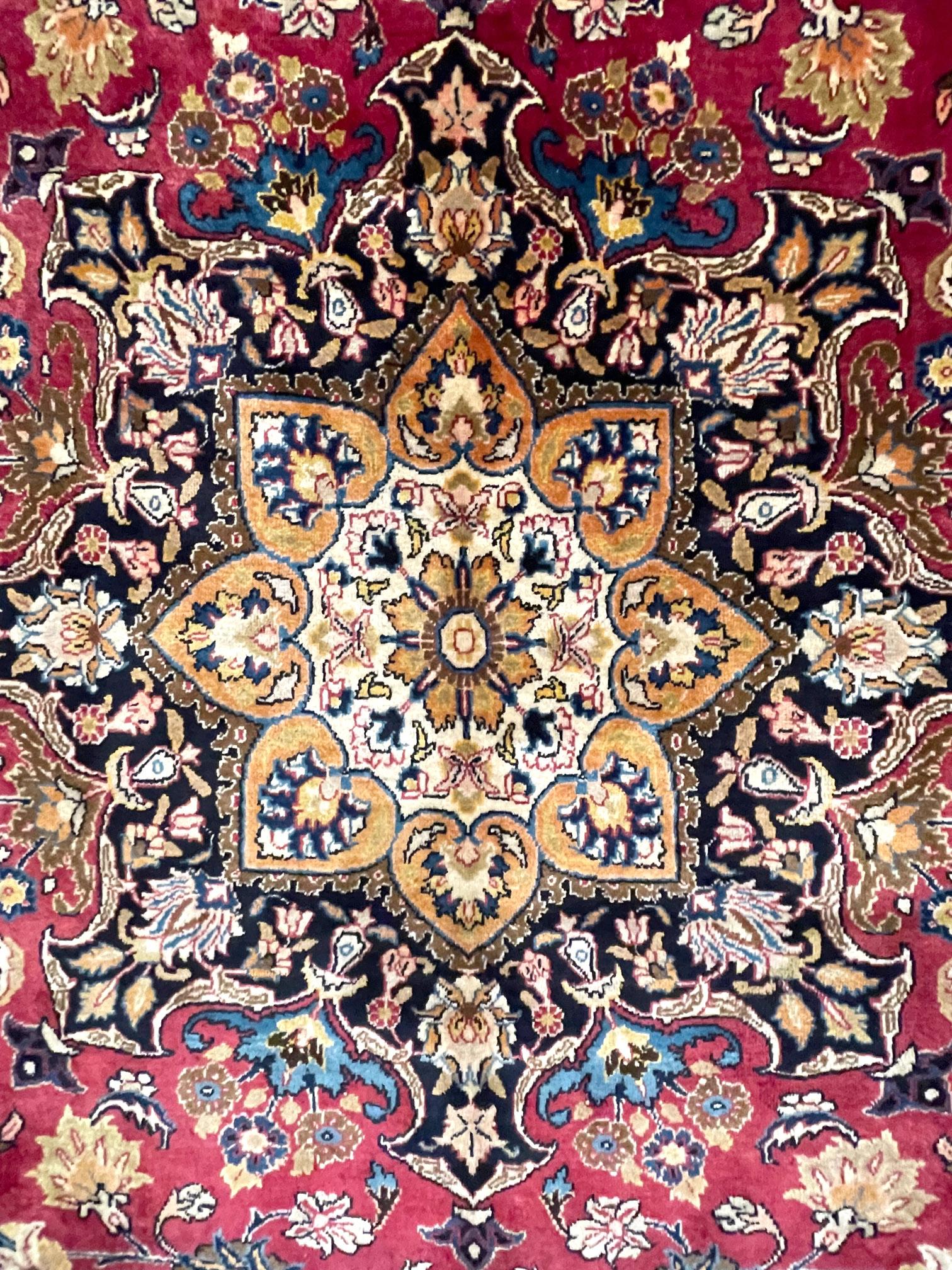 This Mashad rug is another popular member of Persian rug family; with wool pile and cotton foundation circa 1960’s. The design is floral/garden design with a sophisticated medallion with rich color combination. The colors in this rug are red, blue,