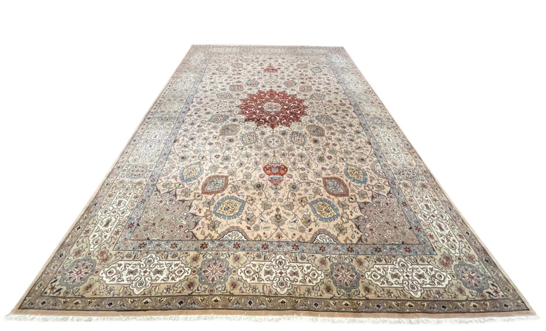 This rug is a hand-knotted Persian Tabriz rug with a great quality. Tabriz is one of the oldest rug weaving centers and makes a huge diversity of types of rugs. This rug features a floral medallion pattern and has been inspired by Sheikh Safi design
