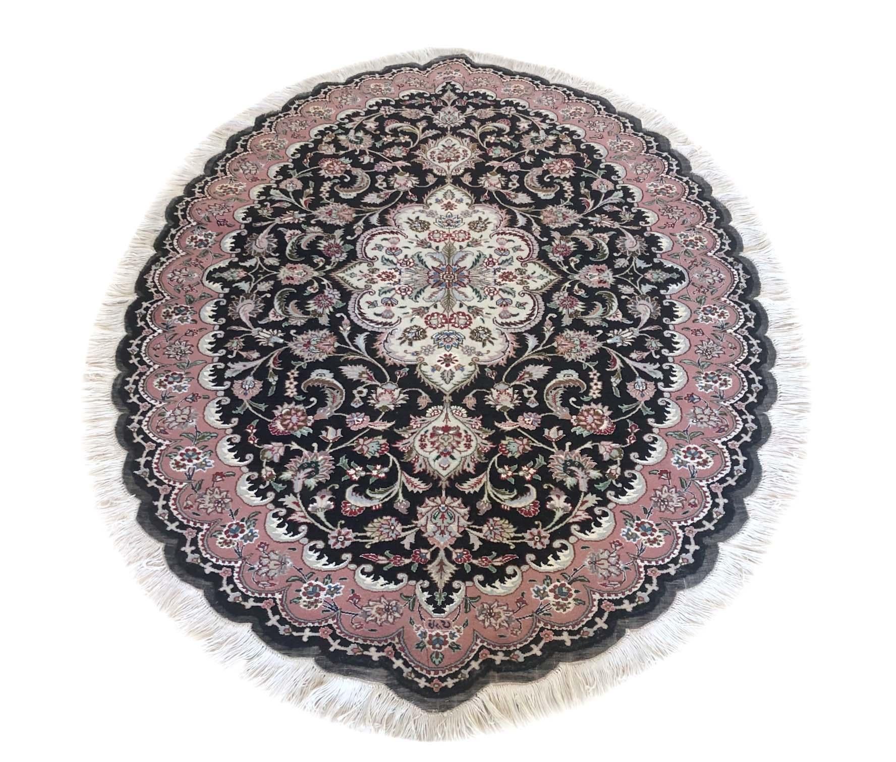 This authentic Persian handmade rug has wool and silk pile with cotton foundation. This beautiful rug is from Tabriz and the design is medallion, floral. The base color is black and the border is mauve. The size is 3 feet 5 inch by 5 feet 3 inch.