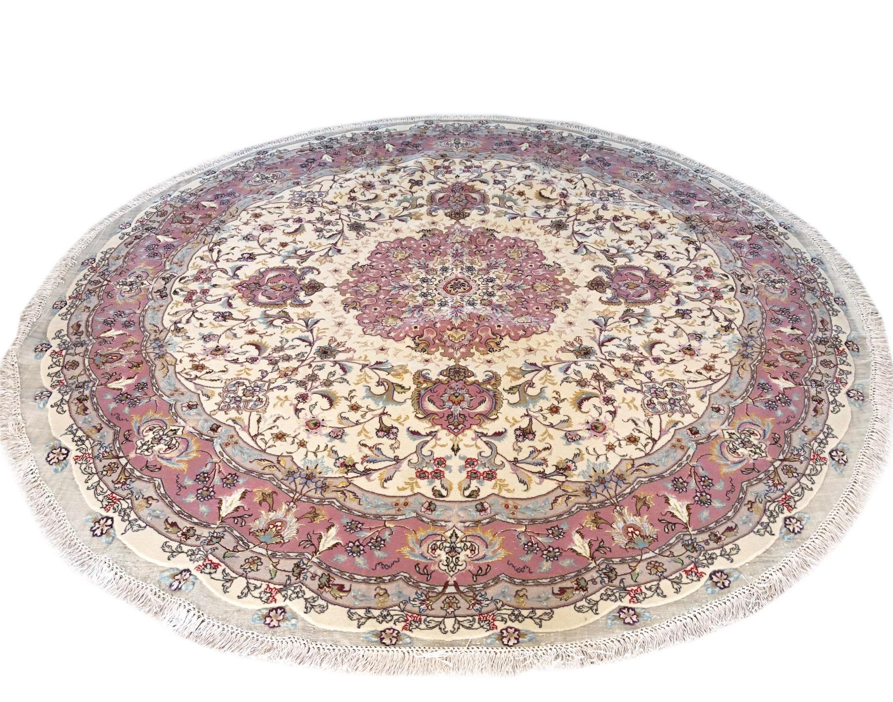 This authentic Persian handmade rug has wool and silk pile with silk foundation. This rug is from Iran, Tabriz and the design is medallion floral (Shirfar Design). The base color is cream and the border is mauve pink. The size is 6 feet 8 inch