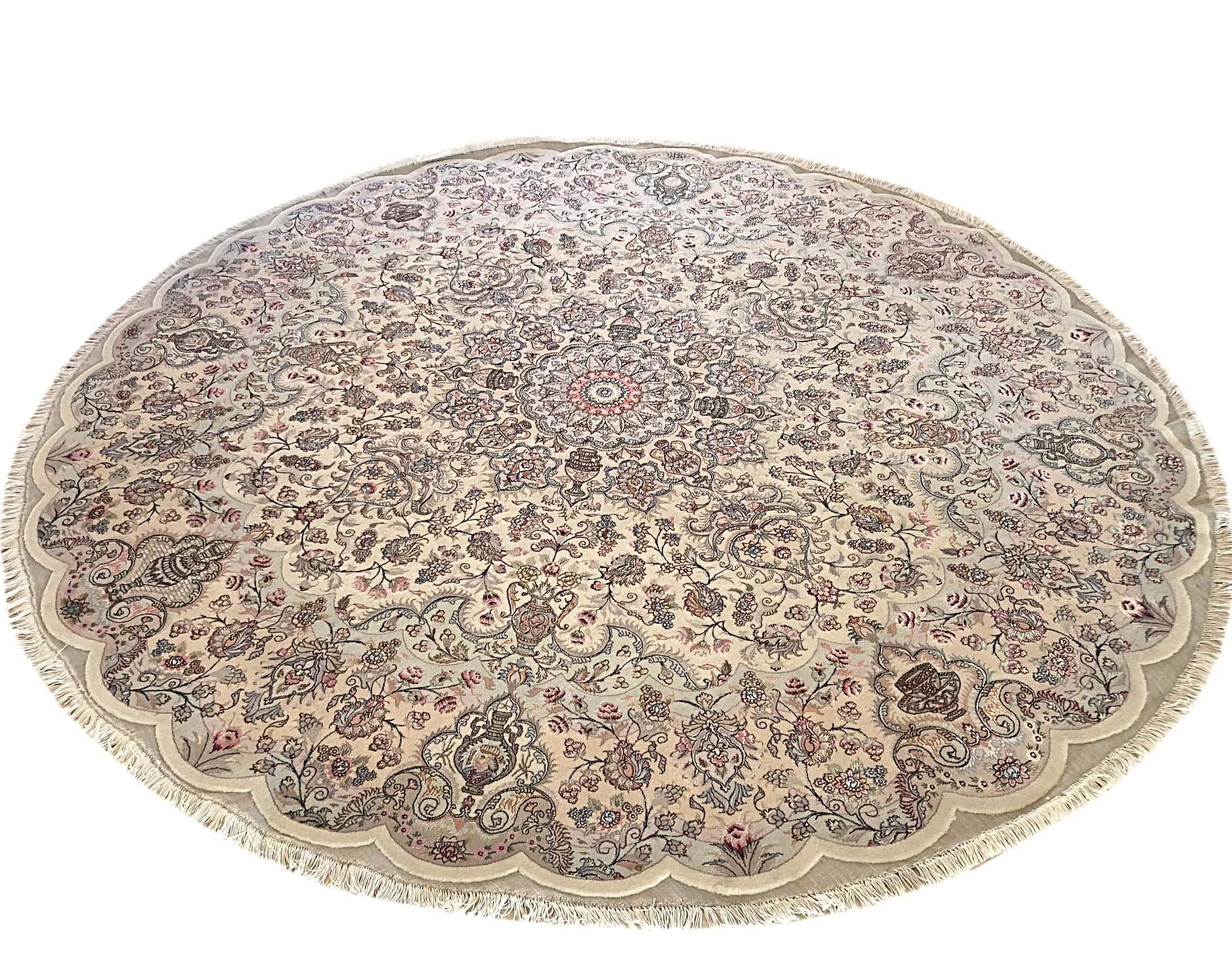 This authentic Persian handmade rug has wool and silk pile with cotton foundation. This beautiful rug is from Tabriz and the design is medallion floral. The base color is cream and the border is light peach. Tabriz rugs are very popular and in great