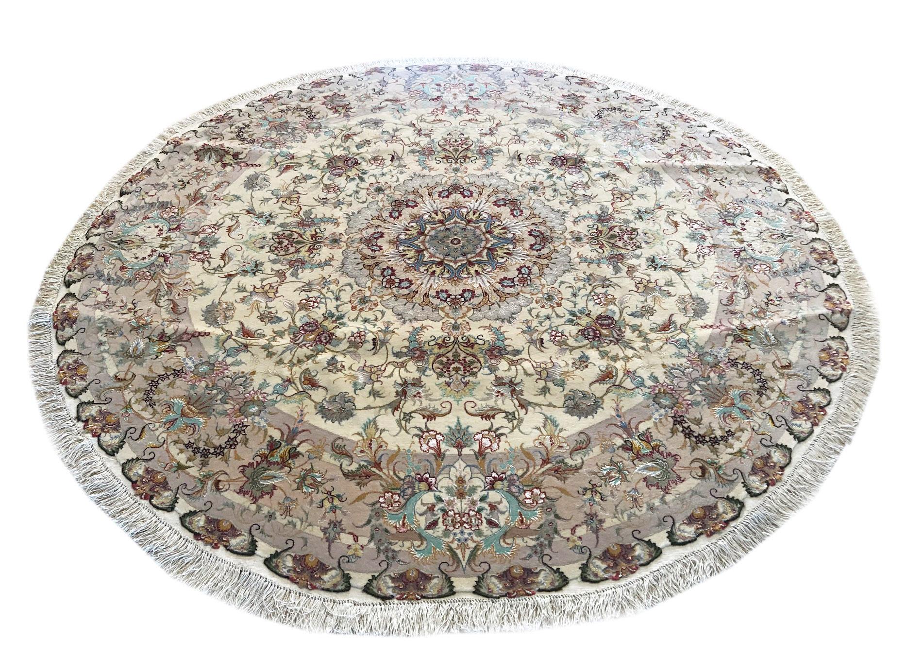 This authentic Persian handmade rug has wool and silk pile with silk foundation. This beautiful rug is from Tabriz and the design is medallion floral. The base color is cream and the border is light brown. Tabriz rugs are very popular and in great