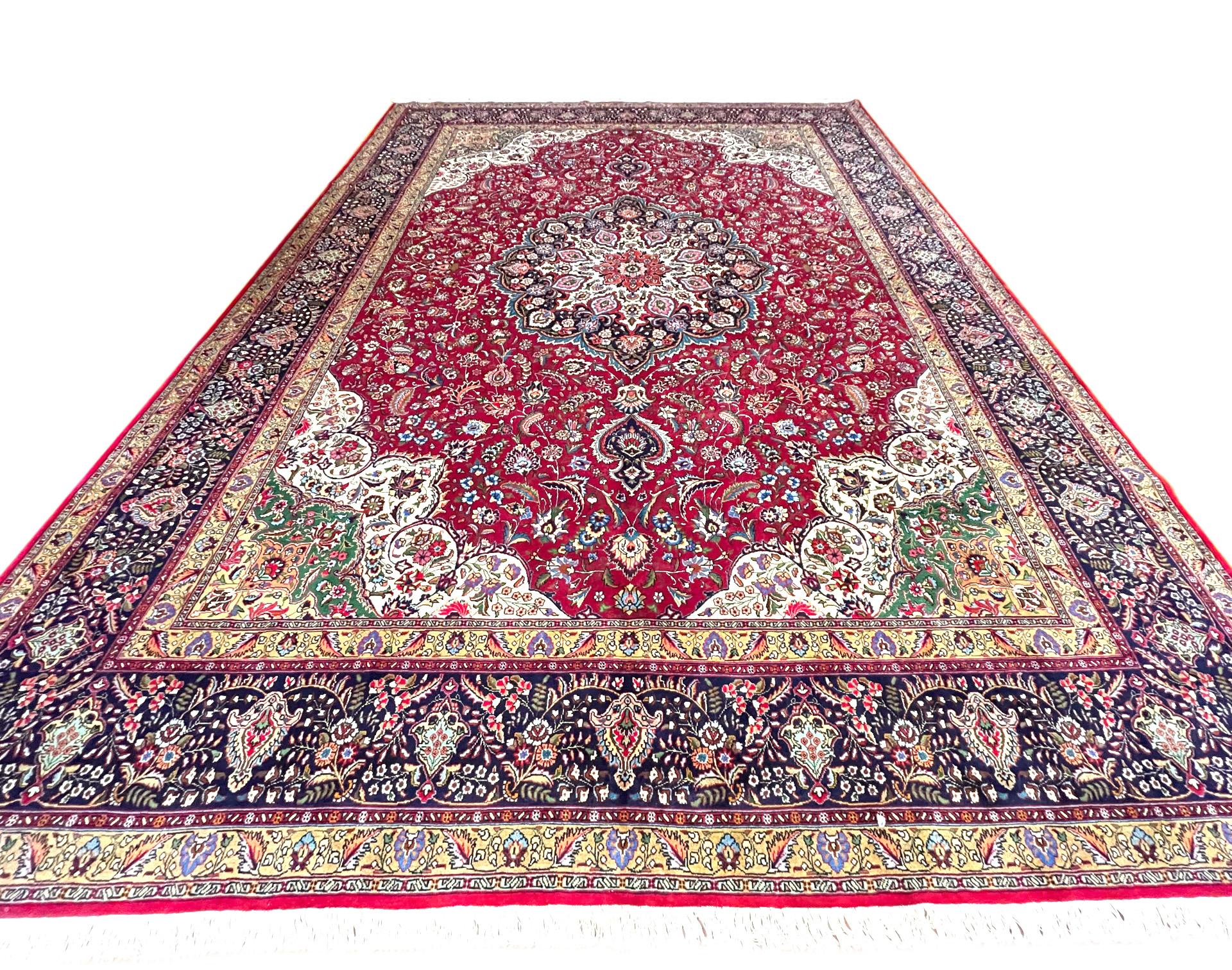 This rug is a hand-knotted Persian Tabriz rug with a great quality. Tabriz is one of the oldest rug weaving centers and makes a huge diversity of types of rugs. This rug features a floral medallion pattern and has wool pile and cotton foundation.