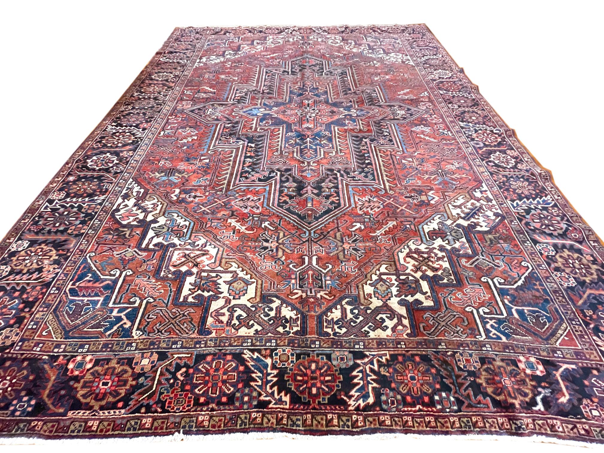 This Persian Tabriz-Heriz rug, Heriz rugs are Persian rugs from the area of Heriz, East Azerbaijan in northwest Iran, northeast of Tabriz. This rug has wool pile and cotton foundation, double hand knotted with a great condition for its age (both
