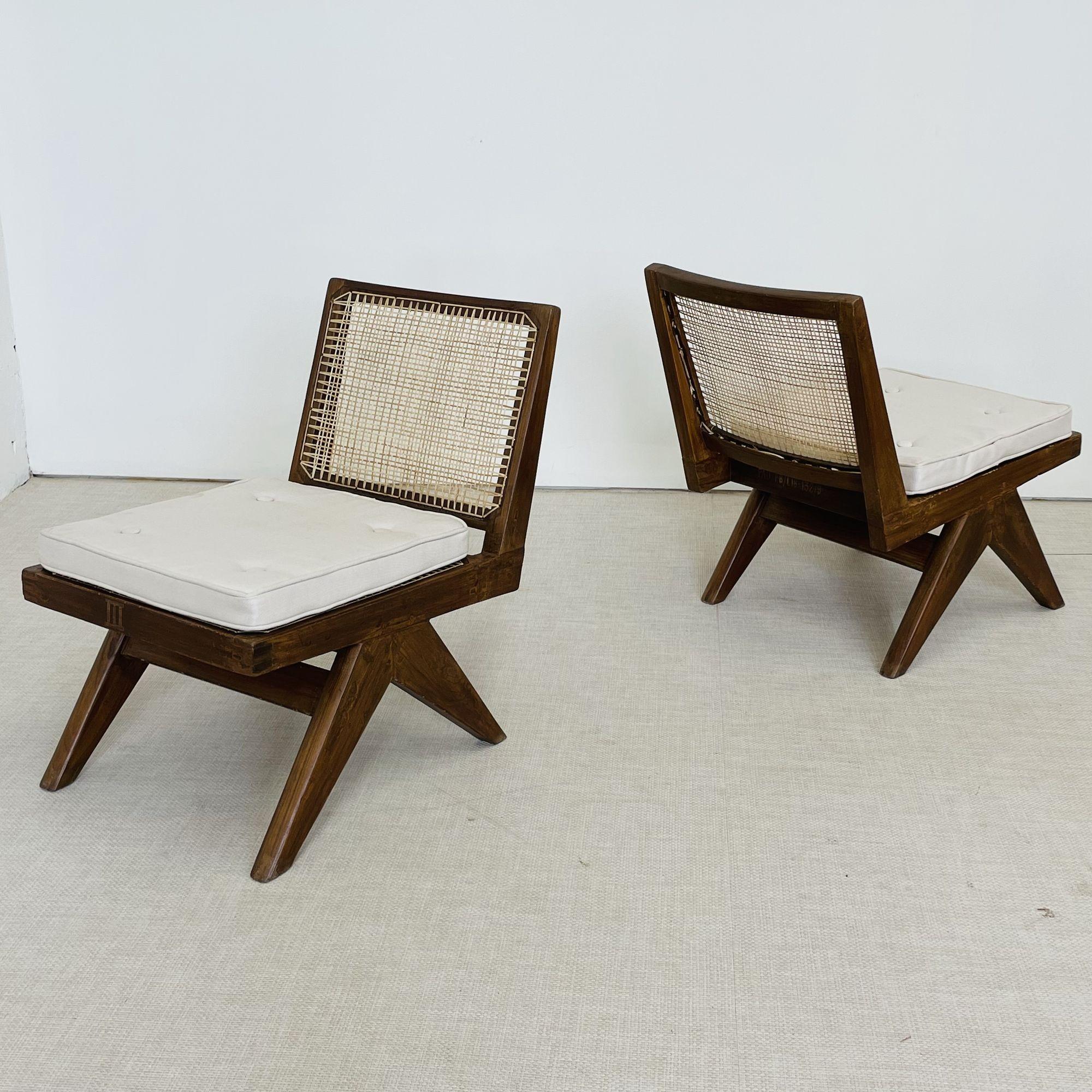 Pierre Jeanneret 'Armless Easy Chairs', Model PJ-SI-35-A
 
This rare armless variation of the low easy chair features a tilted, slightly curved backrest on top of a compass style double sided v-leg base assembly. Both chairs come with new two inch