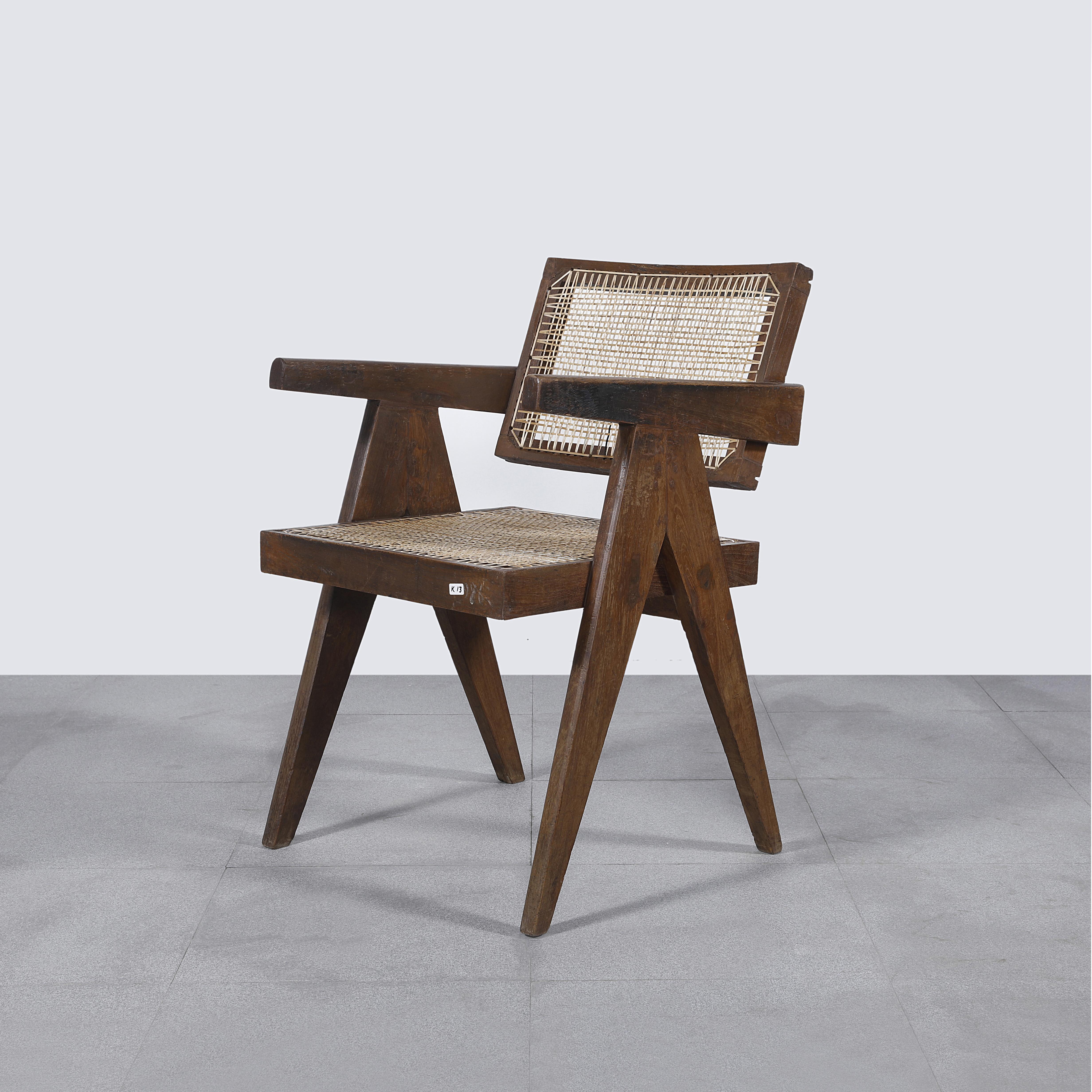 Chair has patinated teak, which gives that chair a strong character, showing all that traces of age and its uniqueness. This piece has authentic letters on the backside that makes it even more valuable, showing a part of the history of Chandigarh.