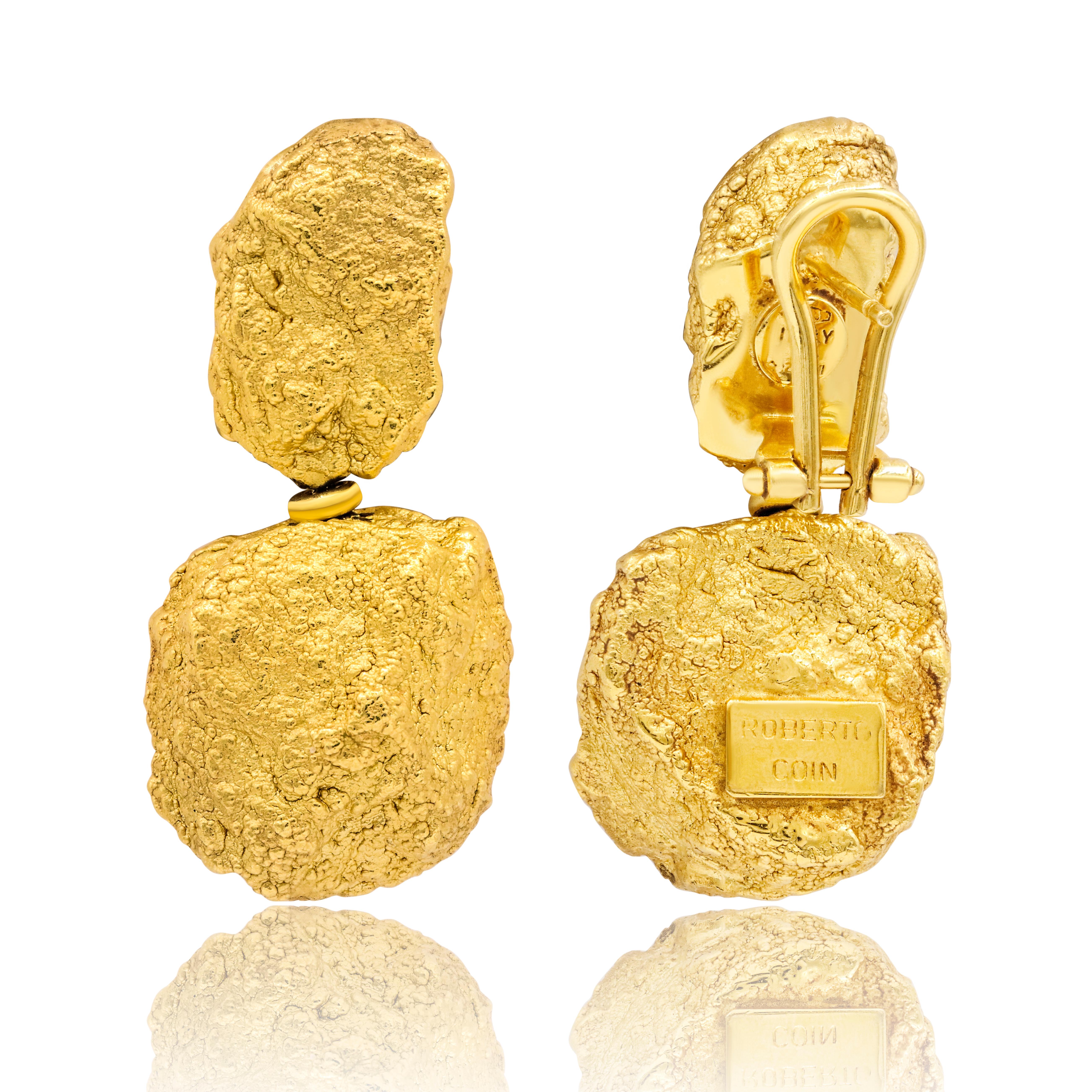 Beautiful statement earrings designed with 18K uncut yellowgold nuggets. The earrings each consist of two hollow gold nuggets, strung on abox link chain with an omega back, and have a combined total weight of 12grams.

This style, which was part of