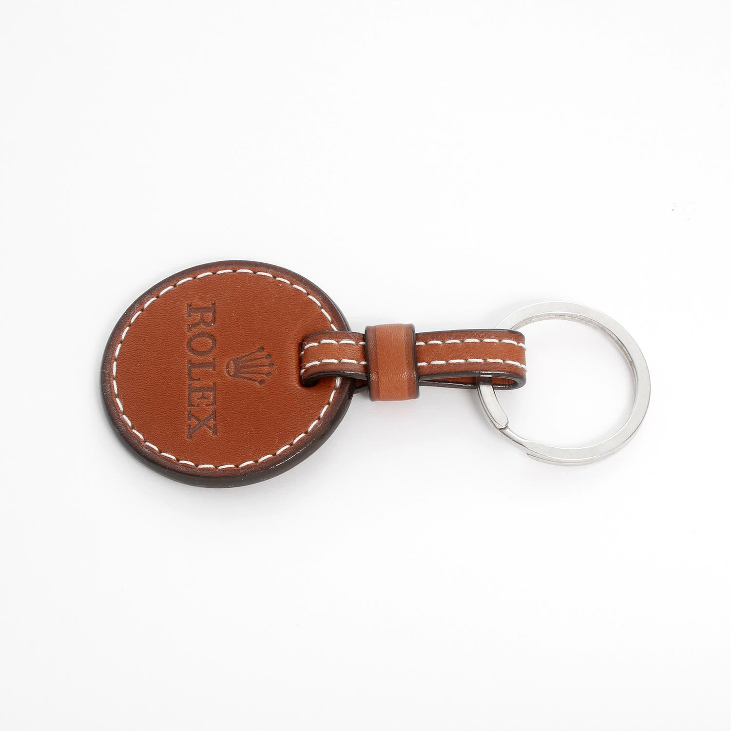 Authentic Rolex Leather Keychain  - Brand new, unused leather keychain with Rolex logo embossed on leather circle. Dimensions: 4 inches long by 2 inches wide .