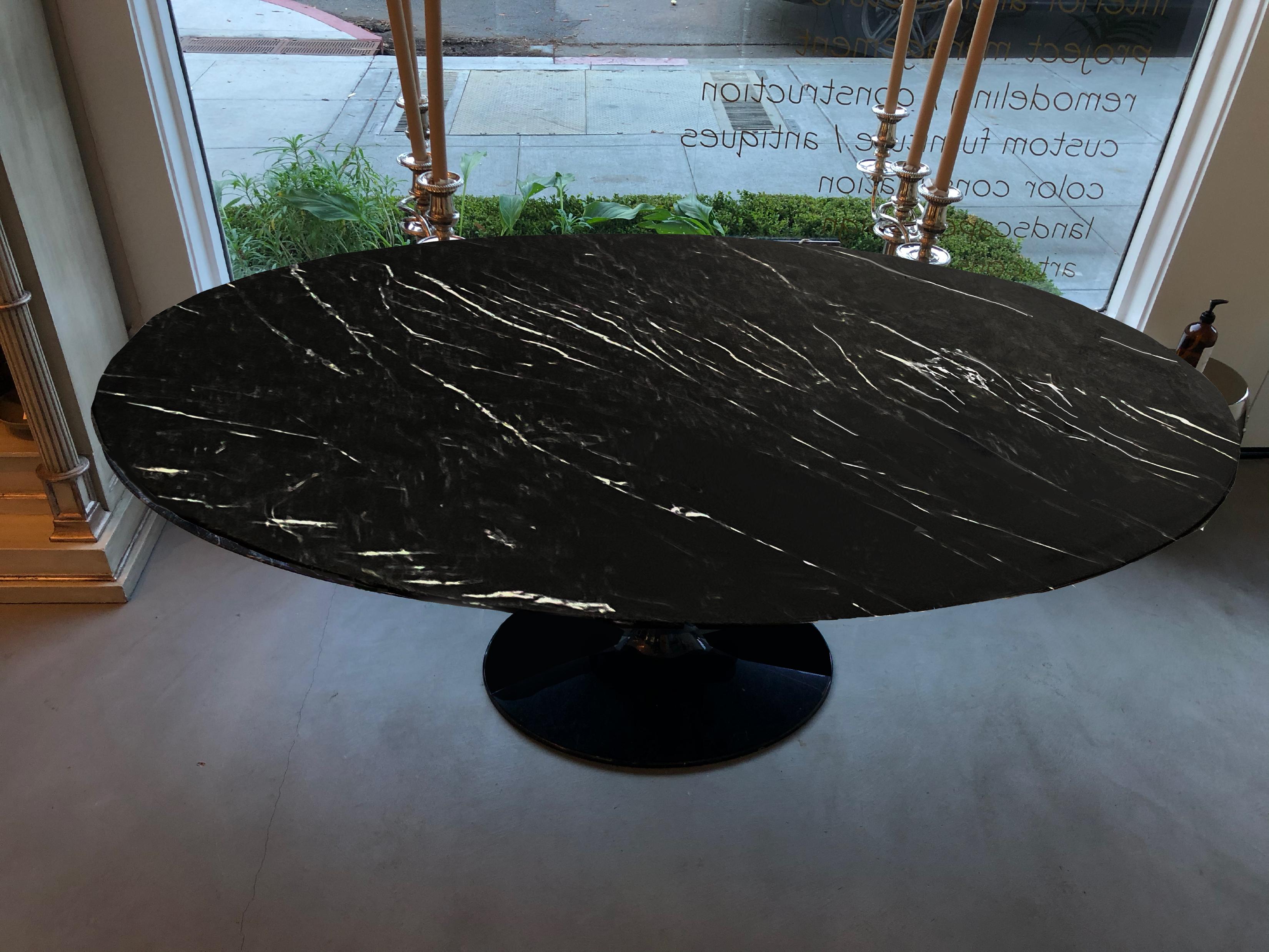 Mid-century authentic Saarinen Tulip oval dining table featuring an original black & white marble top and base.