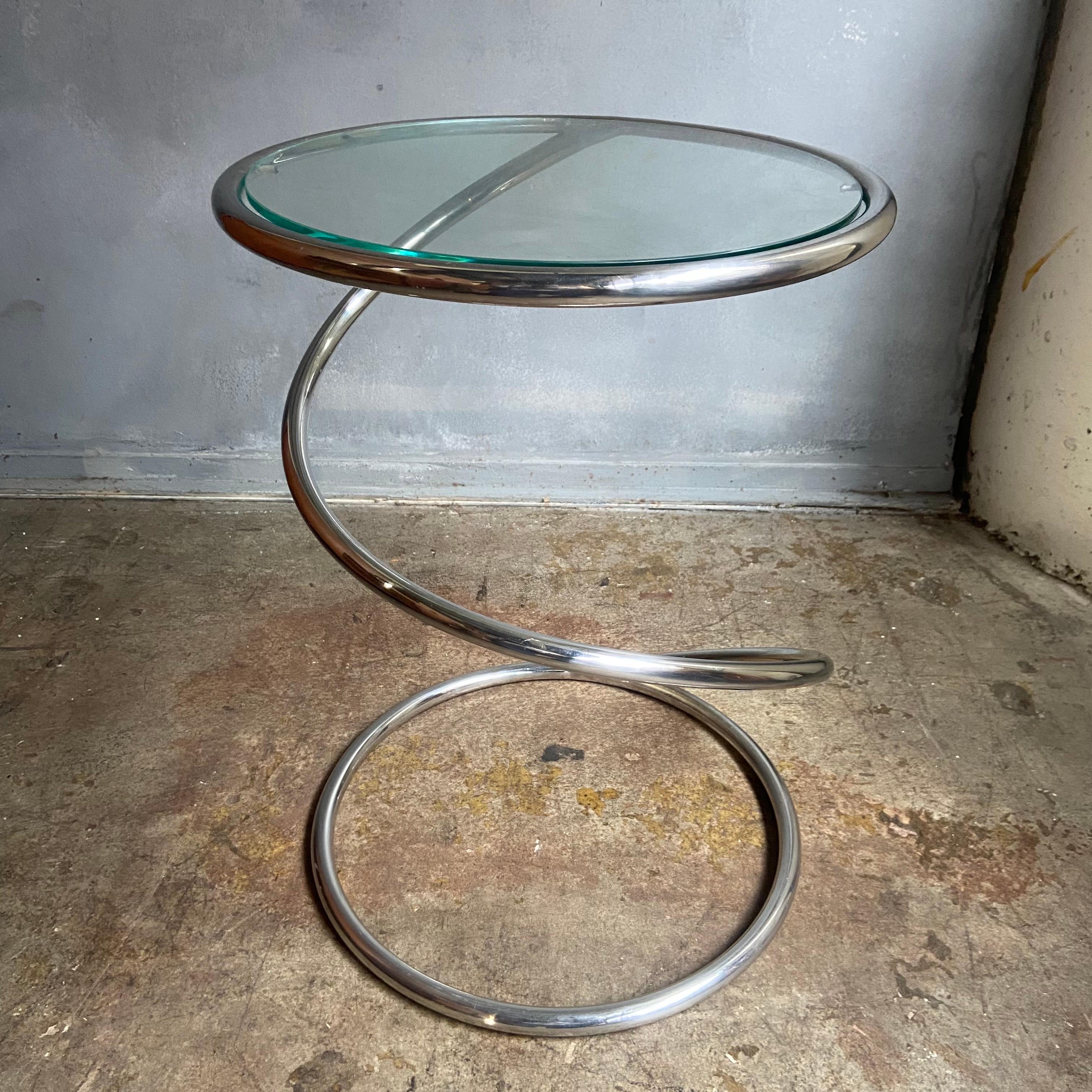 Whimsical Side table in chrome with glass top. Heavy chrome finish on solid metal rod differentiates the original from the copies. Very heavy and sturdy though looking fragile and light. Wonderful design.