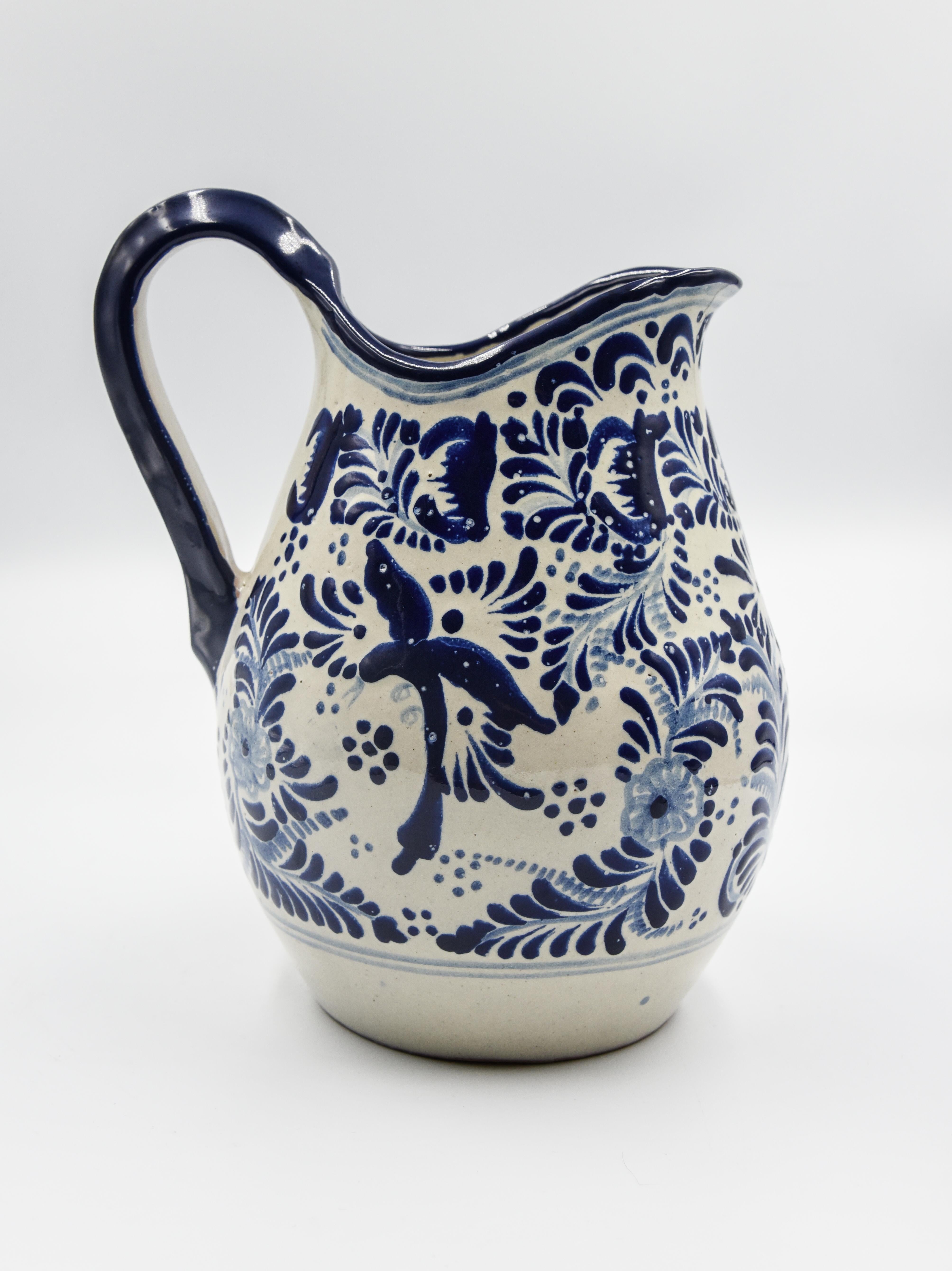 This elegant blue and white pitcher is made of Talavera. Perfect for a decorative piece or useful pitcher for the everyday life. Painted in a traditional poblano style this beautiful vessel is perfect for the kitchen or dinning room. 

The