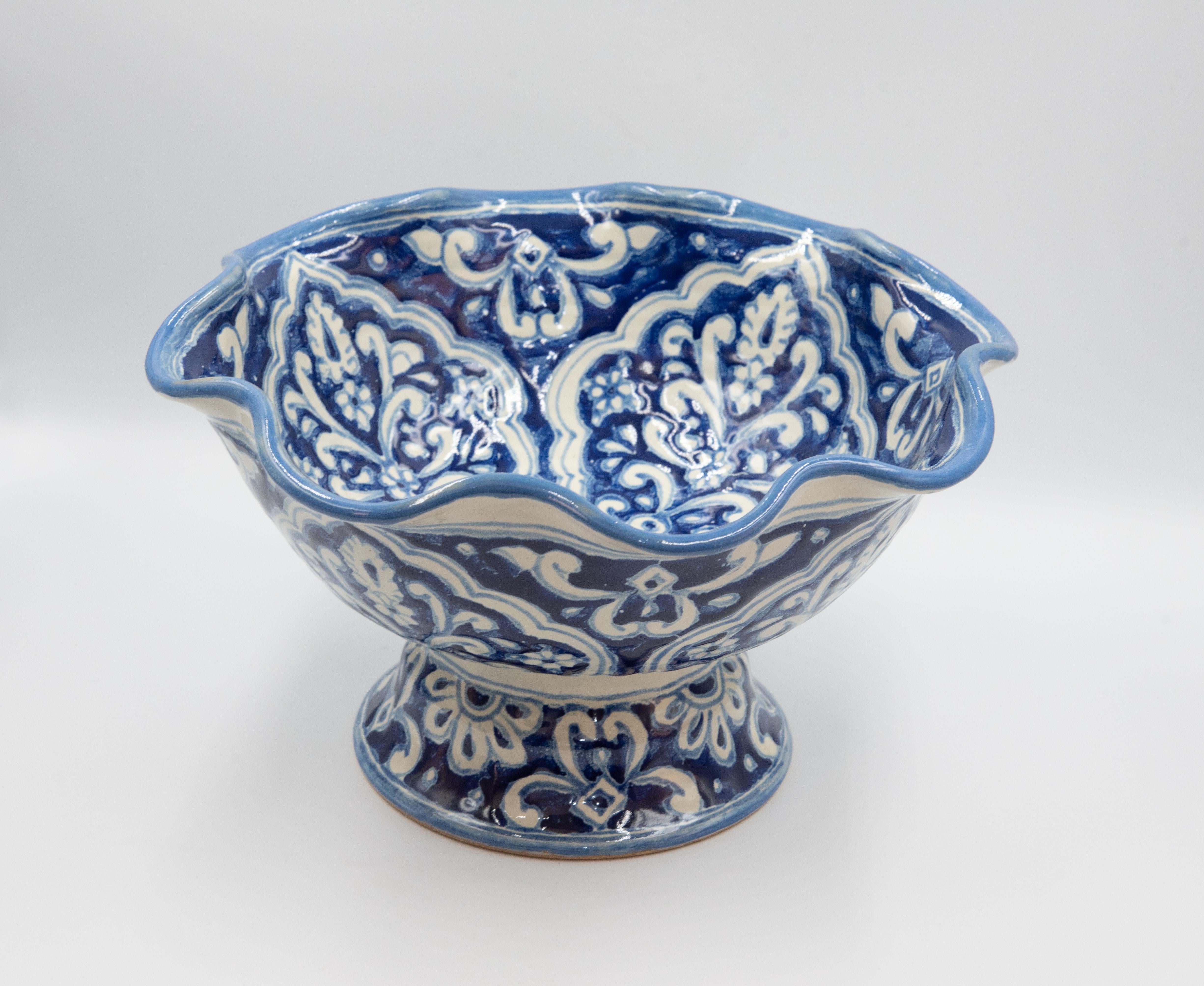 This beautiful Talavera fruit bowl is part of Cesar Torres's traditional work series, using mainly blue and white from traditional Talavera. 

The Talavera is not just a simple painted ceramic: its exquisite decoration is the product of a delicate