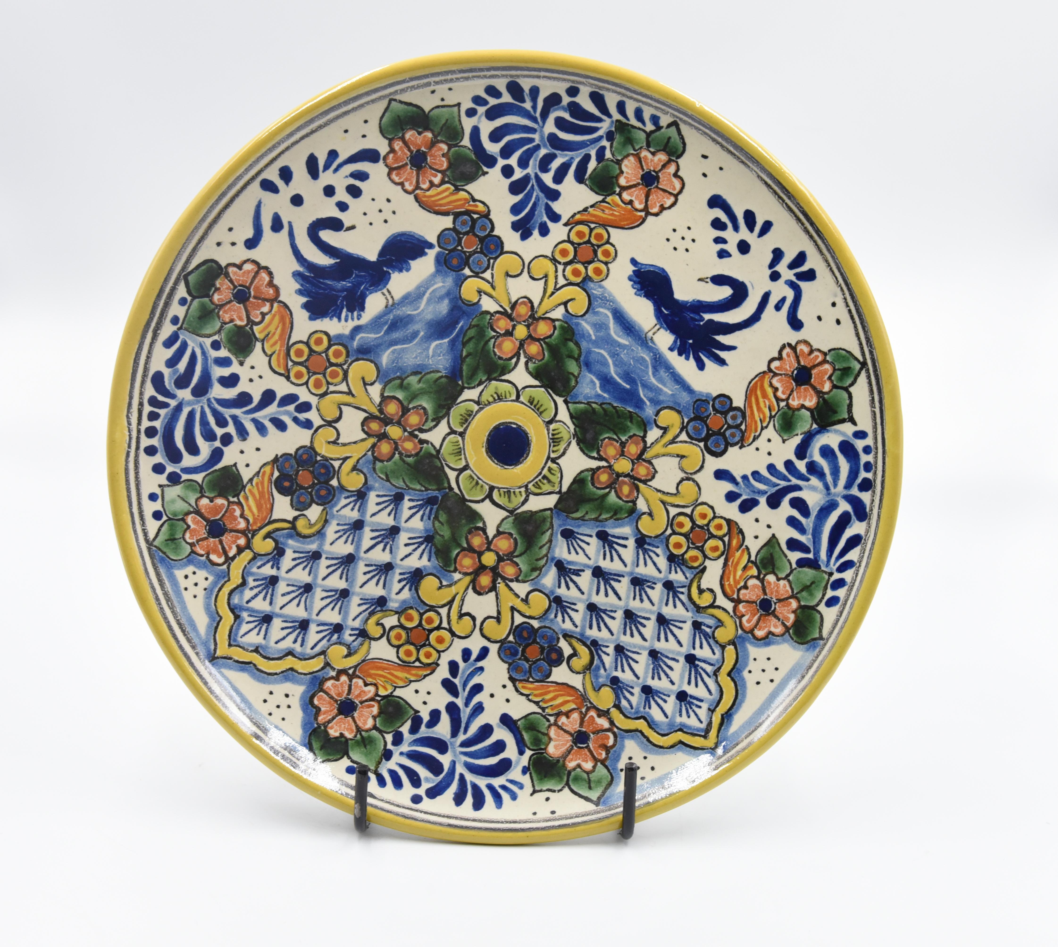 This elegant decorative plate is made of Talavera. Perfect for a utilitarian or decorative plate or wall hanging decoration. Painted in a traditional poblano style this beautiful serving piece is perfect for the kitchen or dining room. 

The