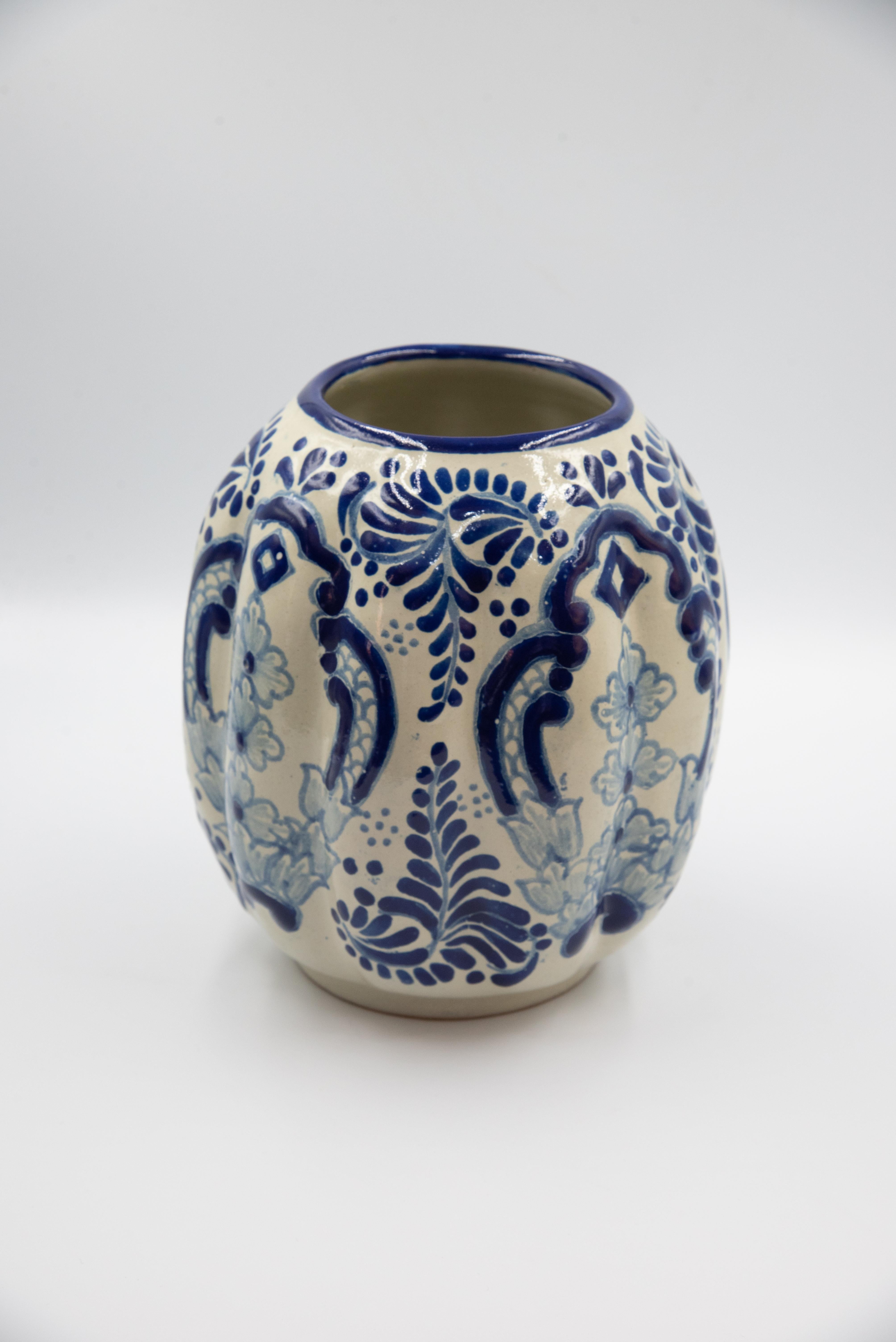 A perfect white and blue flower vase made with the Talavera technique. Artist, Cesar Torres portraits the colonial art of Mexico. 

The Talavera is not just a simple painted ceramic: its exquisite decoration is the product of a delicate process of