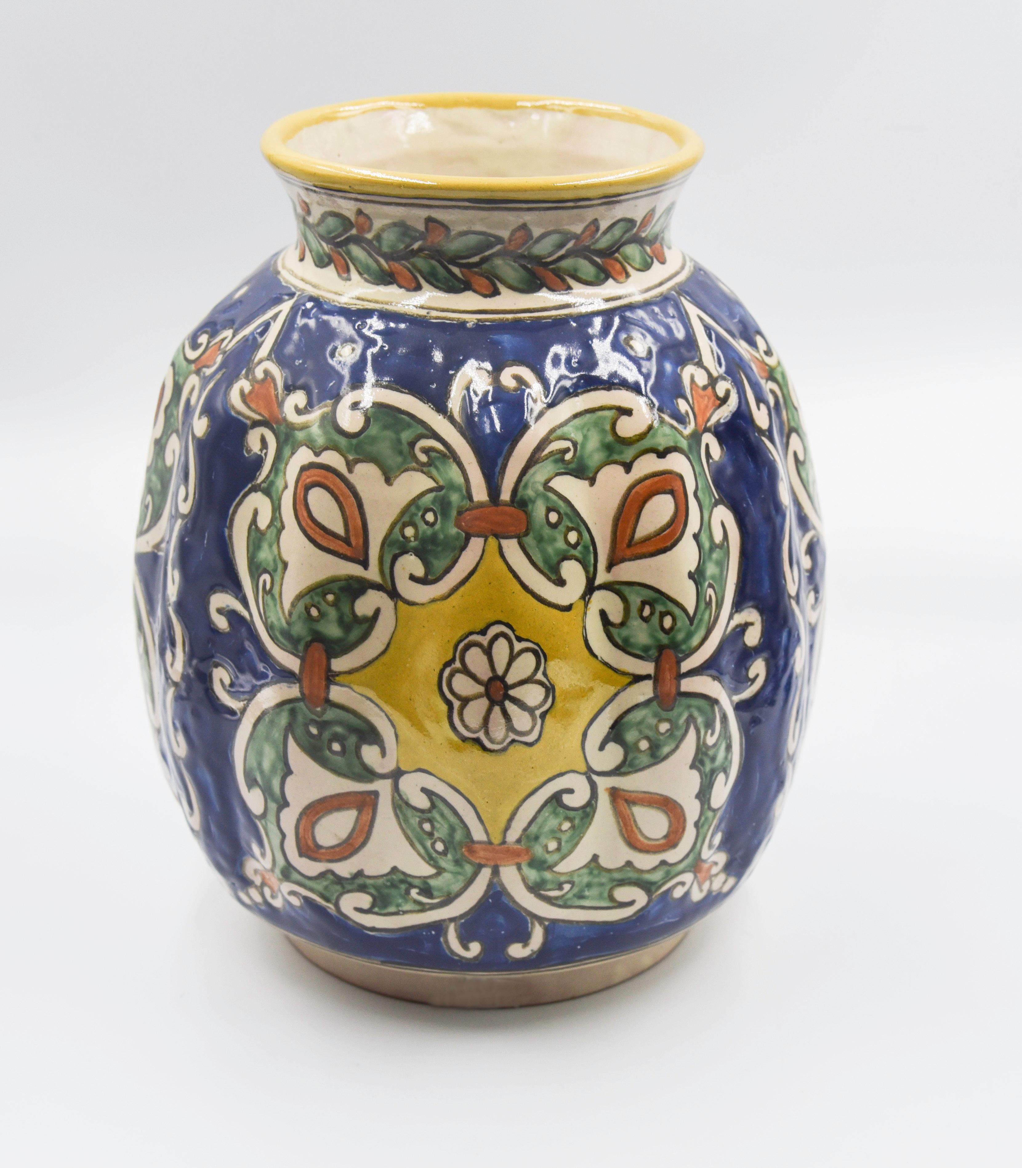 An elegant vintage vase, crafted by master ceramist Cesar Torres, in Talavera technique with a colonial and Baroque design. 

The Talavera is not just a simple painted ceramic: its exquisite decoration is the product of a delicate process of