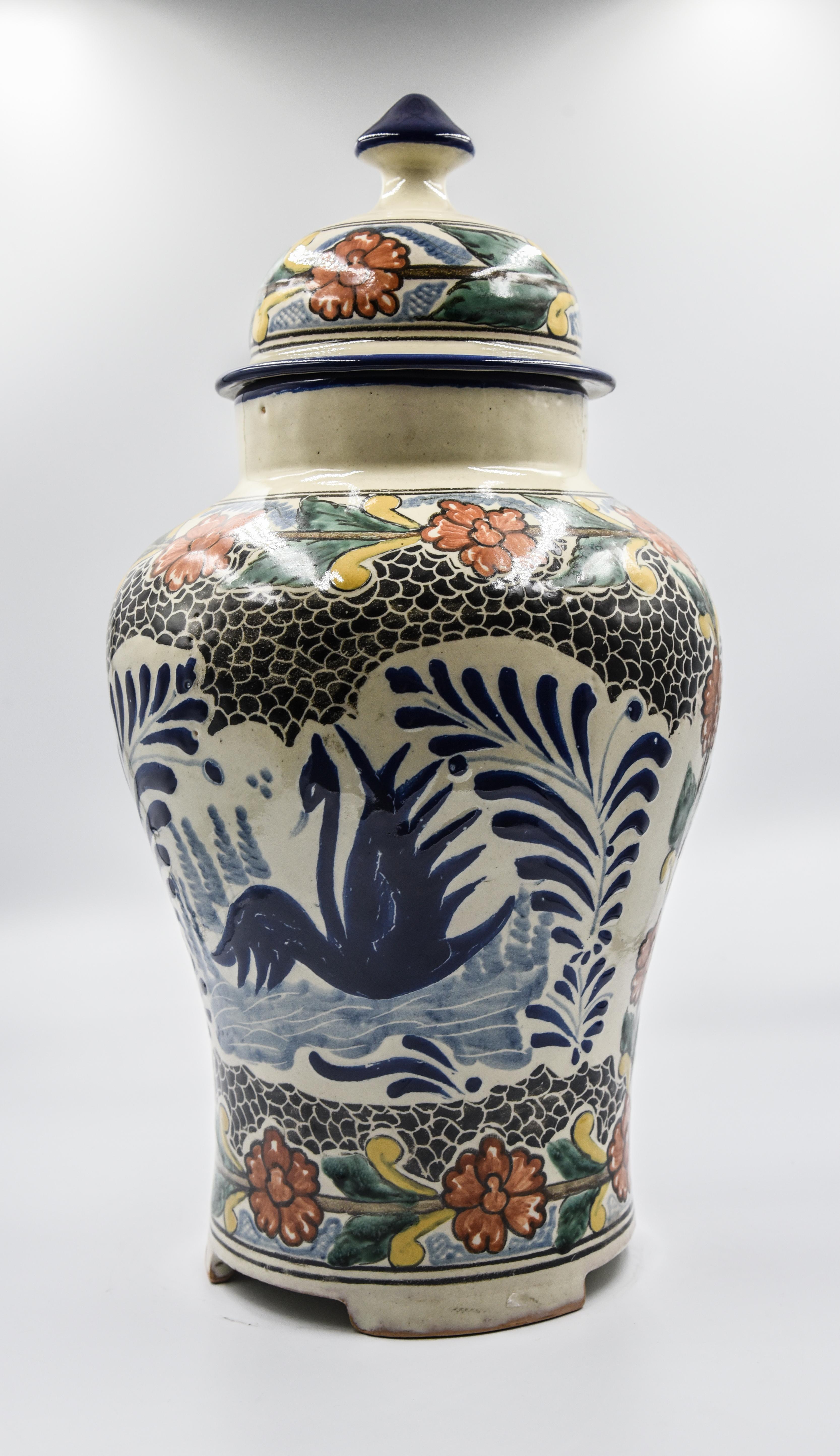 This impressive one of a kind vase is a true representation of Cesar Torres's work. This beautiful vase figure comes with a pointy lid just as a traditional Talavera vase. Its texture and design are however a mixture of colonial and contemporary