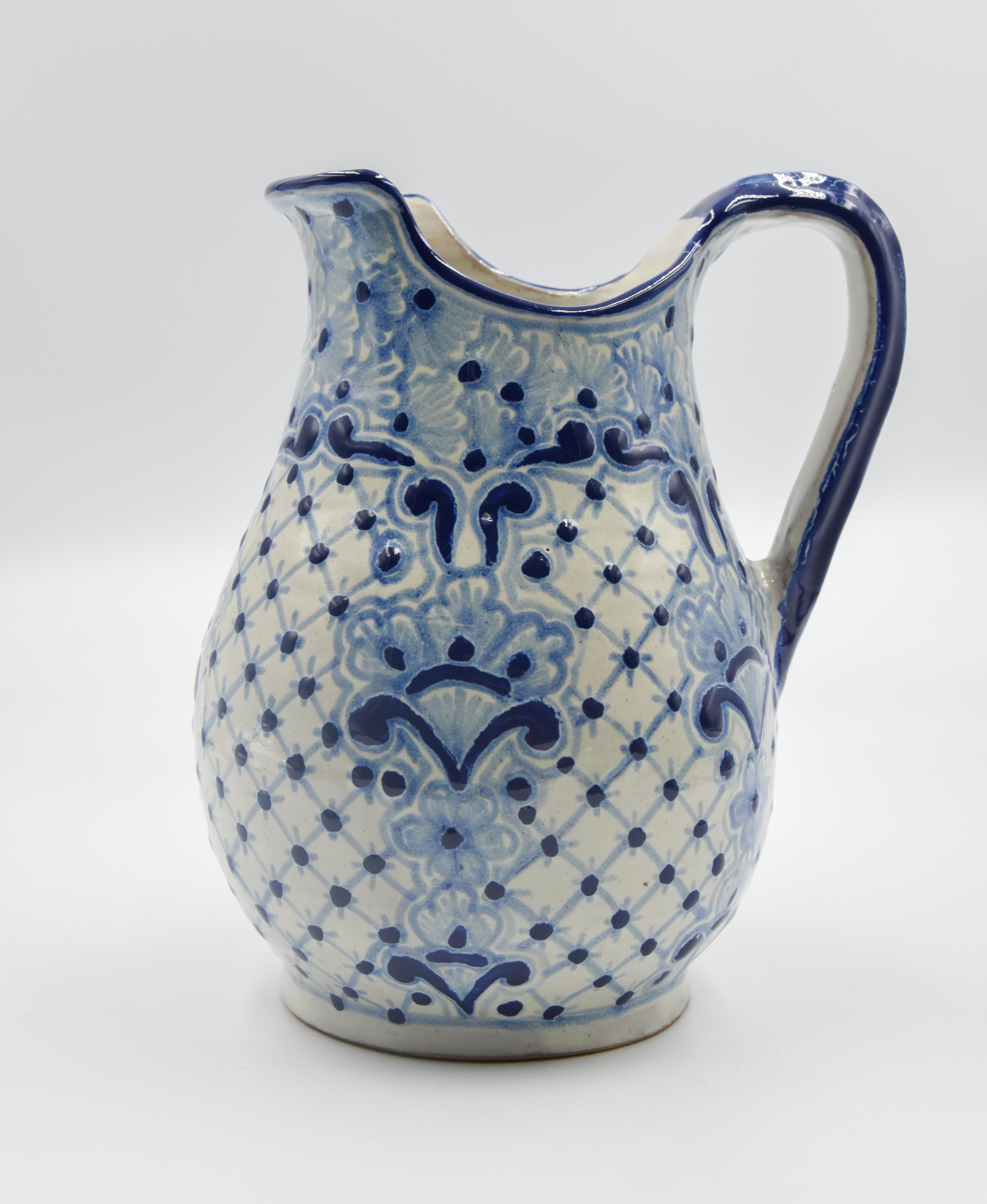 This majolica Talavera pitcher is perfect for a decorative piece or useful pitcher for the everyday life. Painted in a traditional poblano style (blue/ white) this beautiful vessel is perfect for the kitchen or dinning room. 

The Talavera is not