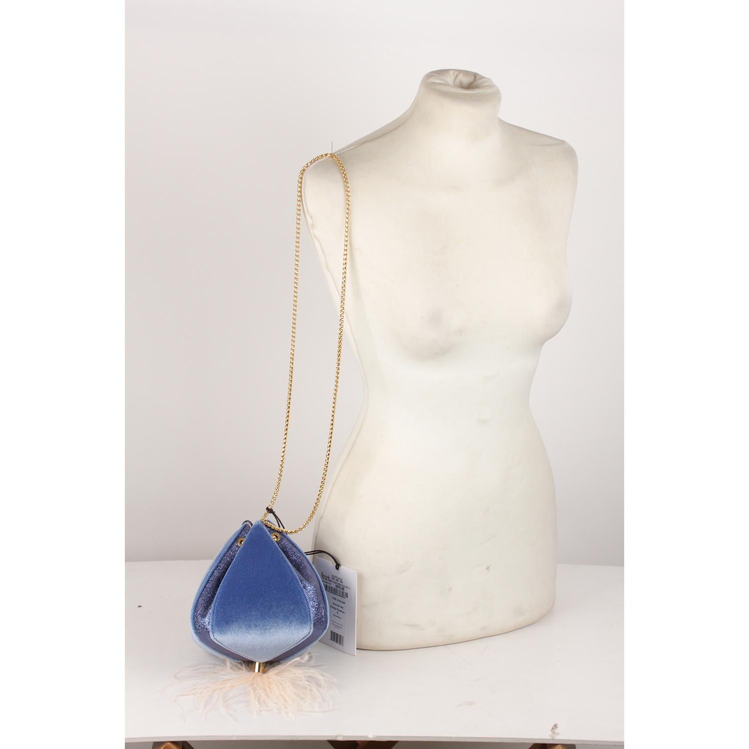 Beautiful THE VOLON 'Cindy' evening bag in blue velvet with metallic blue textured leather. Inspired by Cinderella's pumpkin carriage, the bag features off-white ostrich feather detail on the bottom. Gold metal double adjustable shoulder chain