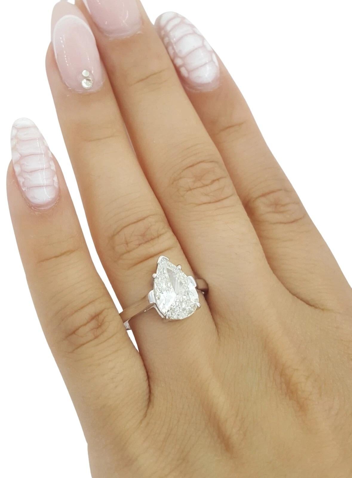This exquisite Tiffany & Co. solitaire engagement ring features a stunning 2.35 carat natural pear brilliant cut diamond set in timeless platinum. The diamond is graded I color and VS1 clarity, with Good Polish, Good Symmetry, and Faint