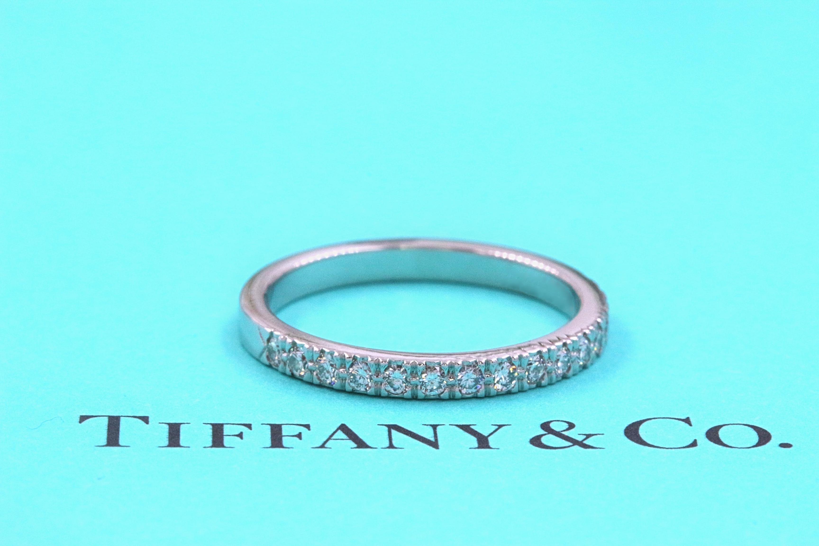 Tiffany & Co.

Style:  NOVO Half-Circle Diamond Wedding Band
Metal:  PT950
Width:  2 MM
Size:  6 - sizable
Total Carat Weight:  0.23 tcw
Diamond Shape:  Round Brilliant
Diamond Color & Clarity:  F - G color, VS clarity
Hallmark: 