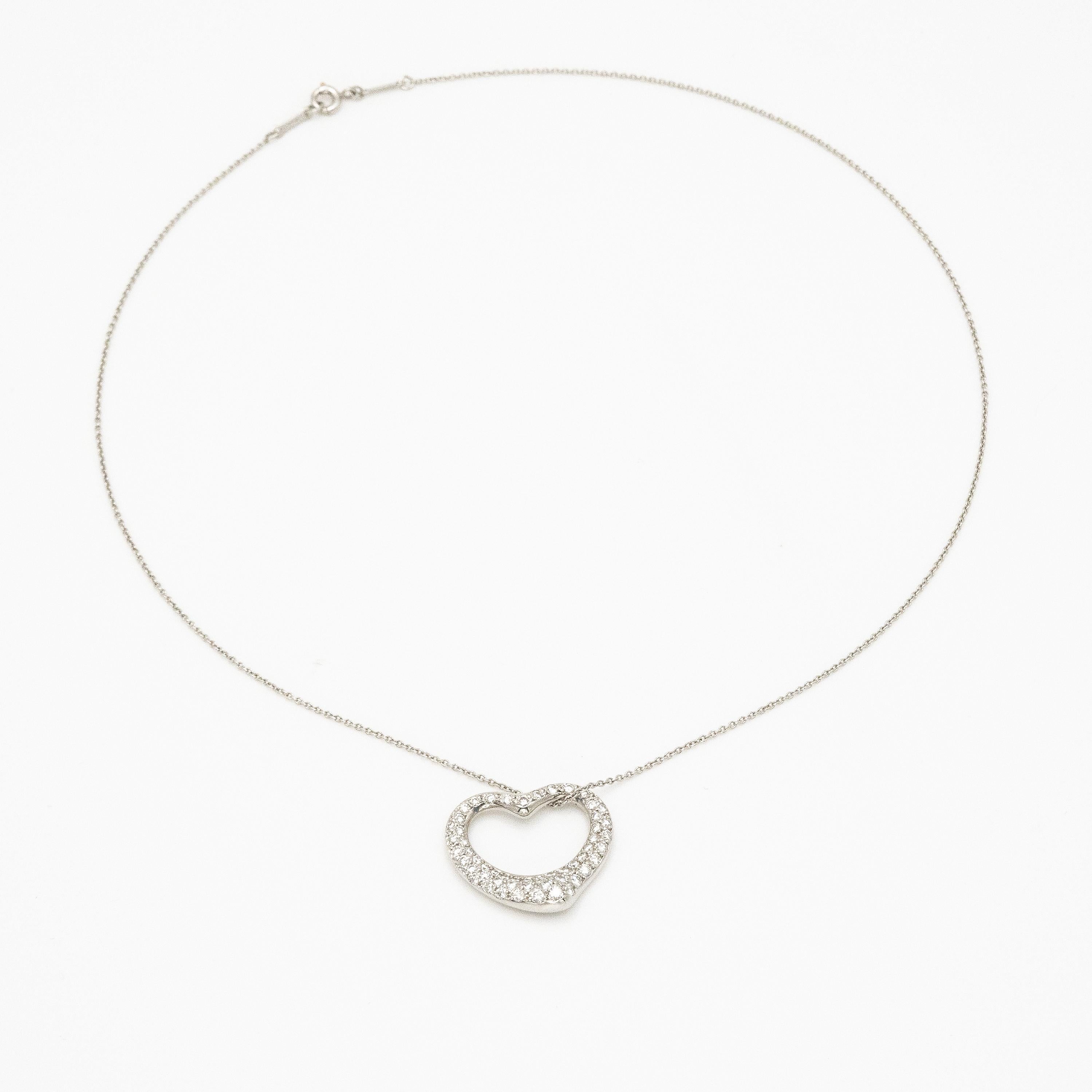 Vintage Tiffany & Co. diamond open heart pendant with round brilliant cut diamonds. Platinum Diamond heart pendant  comes with a platinum chain necklace,

Approximate Gross Weight: 9.50 g
Diamond ~ 0.95 carat

Approximate Measurement :
Chain - 16