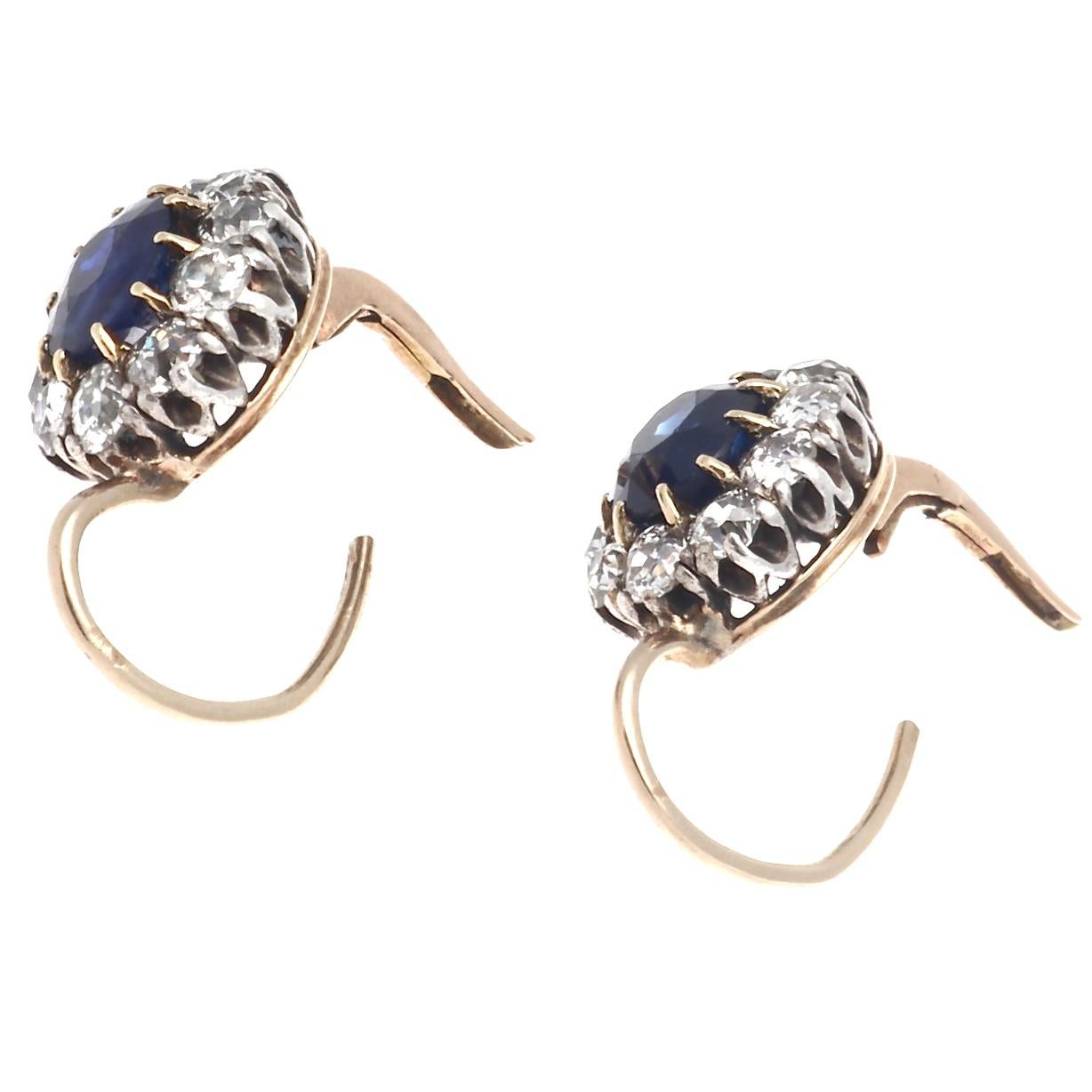 Beautiful authentic Victorian sapphire diamond leverback earrings. Featuring GIA certified no heat faceted oval sapphires weighing 1.30 carats each. The vivid sapphires are surrounded by a cluster of 20 old European cut diamonds that weigh