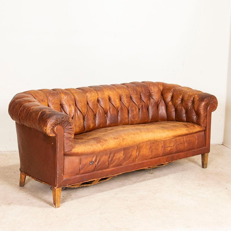 The unique appeal of vintage leather over something new is difficult to describe, but it is the worn patina that comes slowly over time that creates the depth of character in an aged leather sofa such as this one. Added to the classic style of a