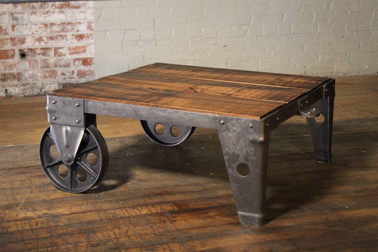 Authentic, original Vintage industrial modern coffee table or cart, made from rough sawn pine, steel, metal, and cast iron. Wood top measures 32