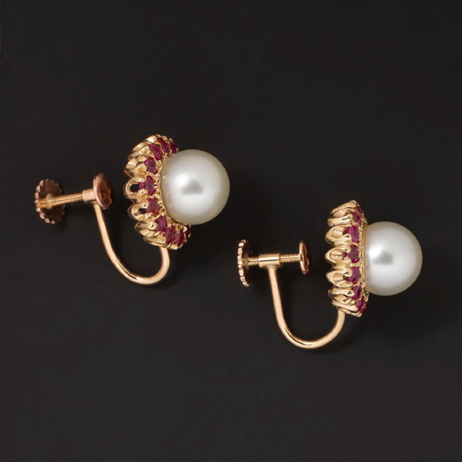 Gorgeous vintage pearl and ruby earrings have a classically glamorous design with rich color and contrast! The earrings feature two large pearls surrounded by halos of rich red natural rubies! The rubies have gorgeous luster and a bright red color