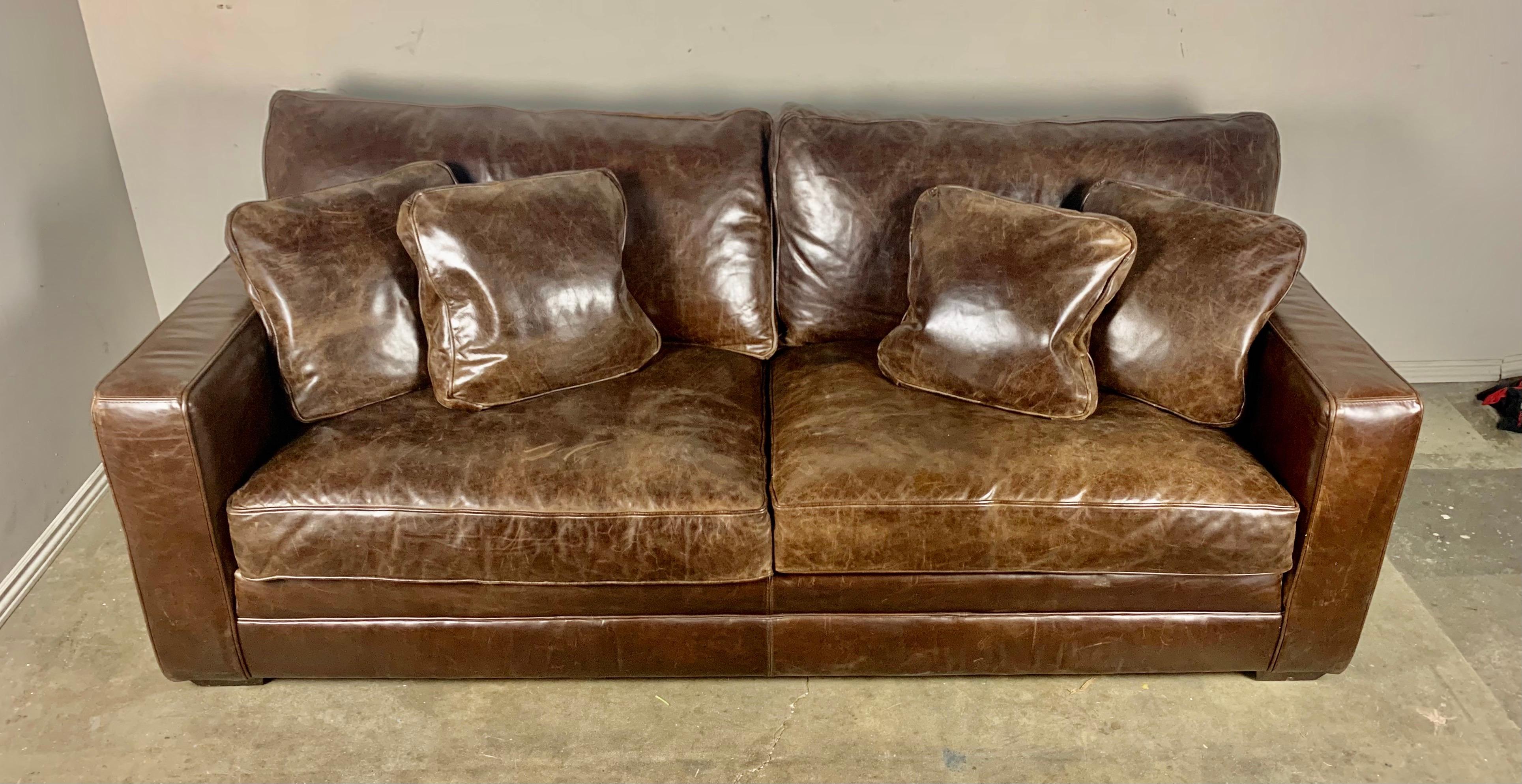 Authentic vintage leather sofa with loose cushions and leather throw pillows included.