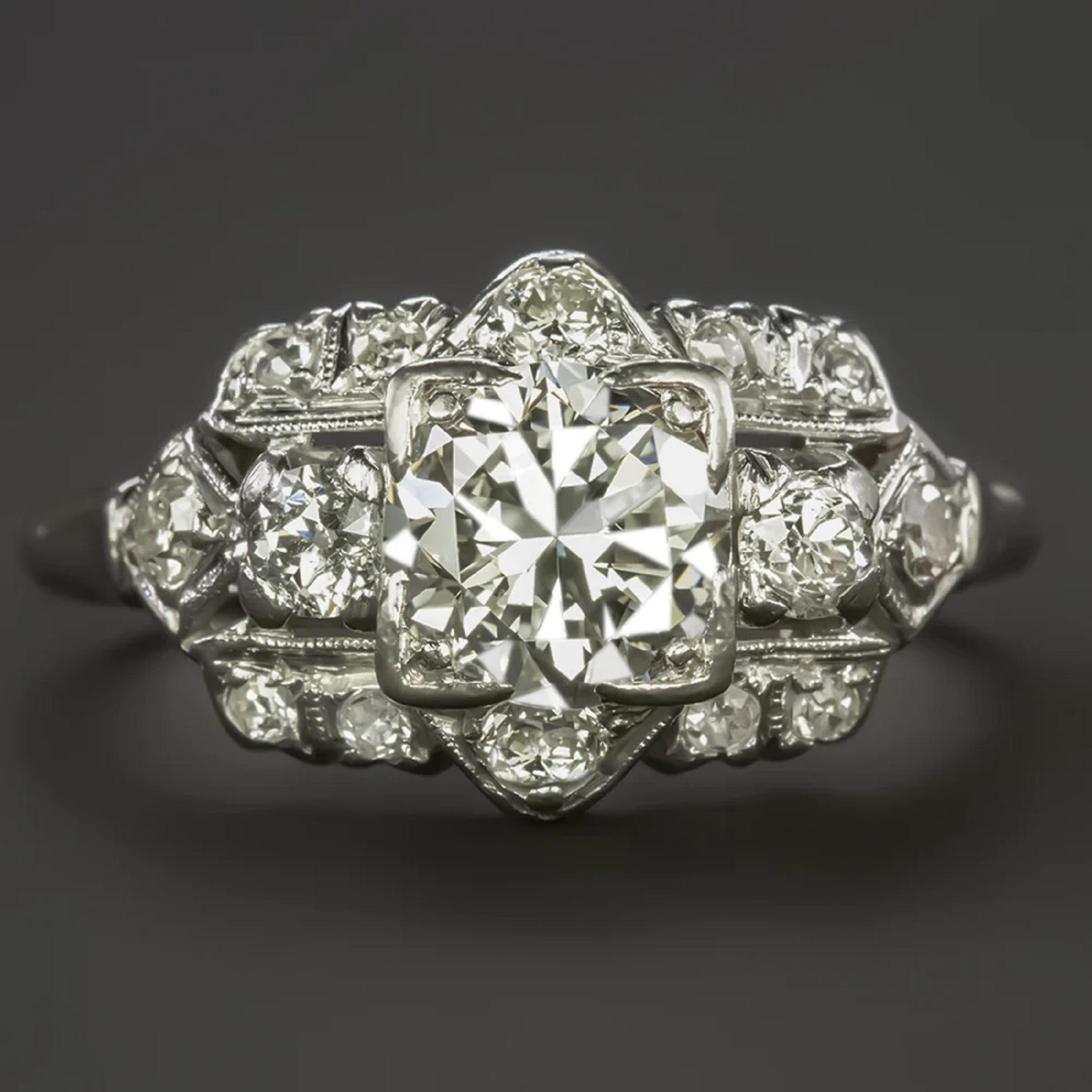 A gorgeous vintage diamond ring has a unique and elegant design with a gorgeous and high quality 1 carat diamond center, hand perfected geometric details, and a diamond encrusted face. Crafted in solid platinum, this is a very high quality piece