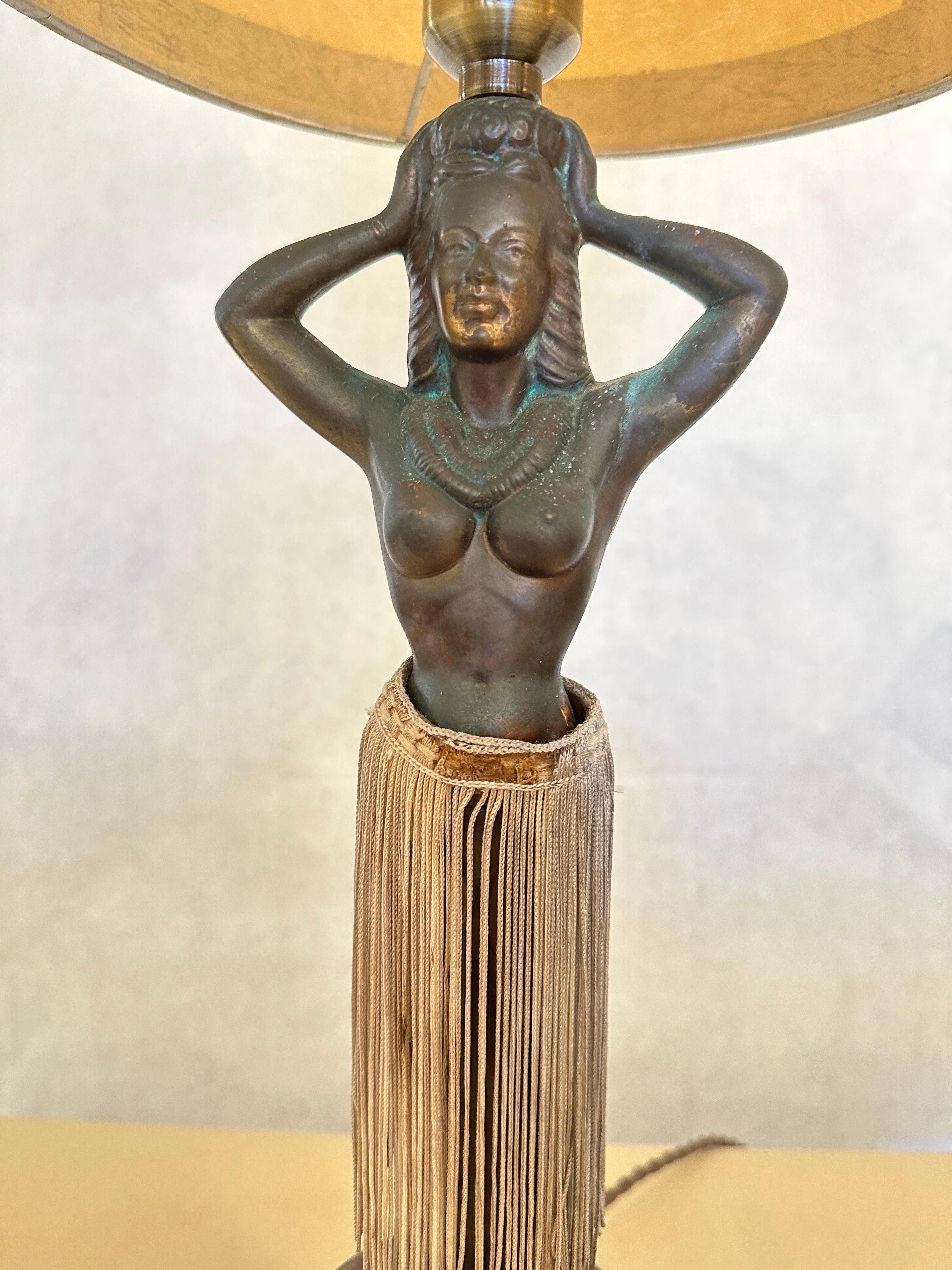 Rare and authentic post WW II era Hawaiian Hula Girl table lamp that undulates her hips with the flip of a switch. Whimsical, vintage electric copper patinated metal hula girl with original silk fringed skirt. Turn her on and be hypnotized by her
