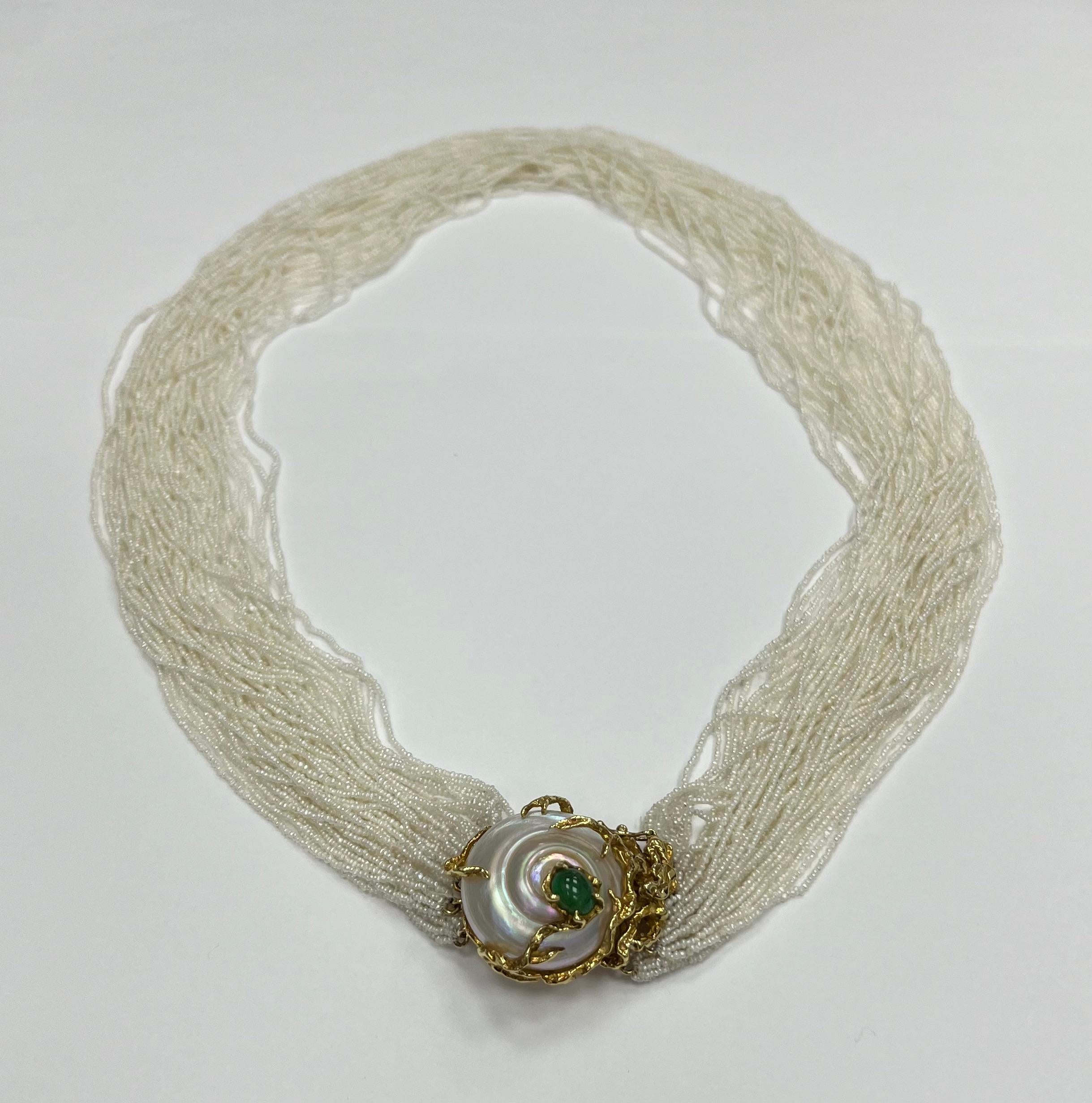 1950' Arthur King multi strand natural seed pearl necklace
with 18K yellow gold mother-of pearl and cabochon emerald Clasp
Marked: King 18K 
Approx 20.5 inches long