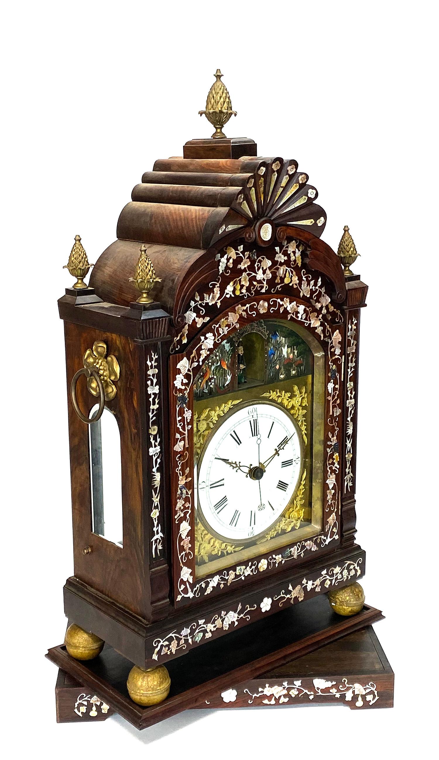 Here for your consideration is a large Chinese Canton bracket clock. The gorgeous ebony case is decorated with beautiful mother of pearl inlaid on the front. There are 5 brass pineapple form finials on the top to make the appearance of this clock