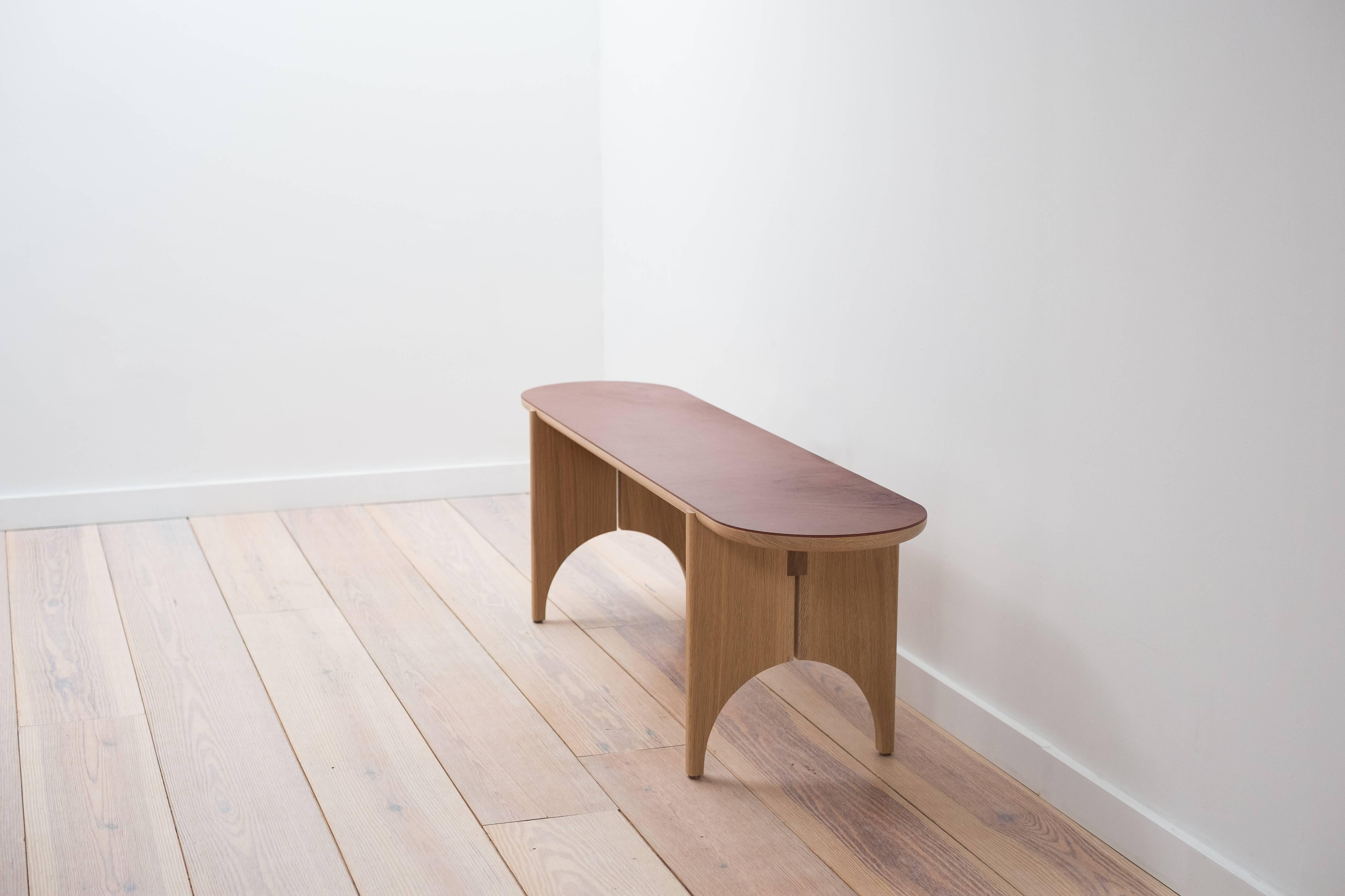 With its distinct reference to Shaker design, the Autumn Bench blends traditional concepts with a contemporary form. Its crescent shaped legs are constructed from hand-selected white oak, and its top is in laminated in hand-finished, full grain