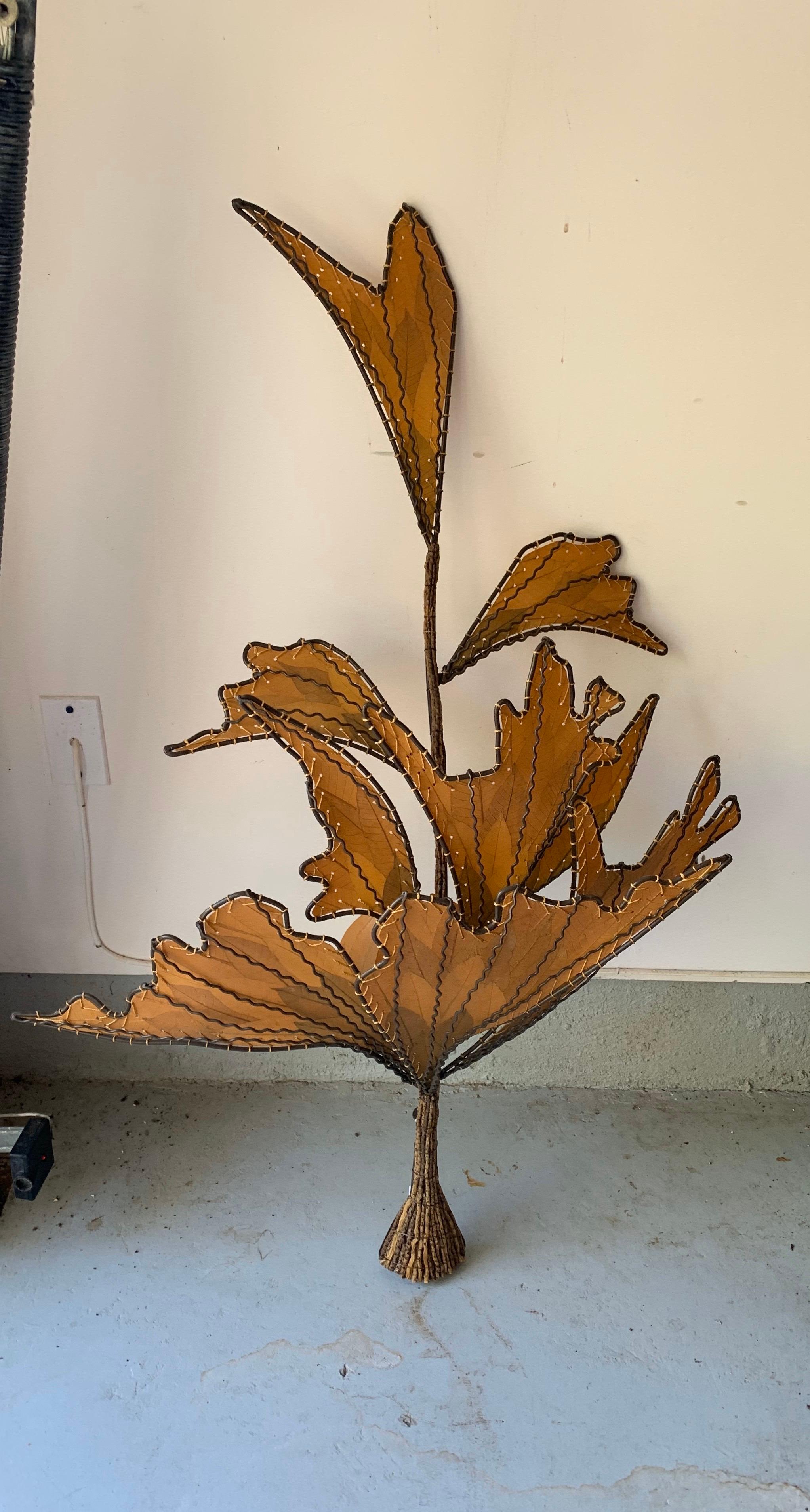 A large pair of metal and resin sconces in the shape of stylized leaves branches.

Electrified for USA, each sconce takes a standard bulb, 60 watts max.

Dimensions:
47 inches H x 31 inches W x 11 inches D.

  