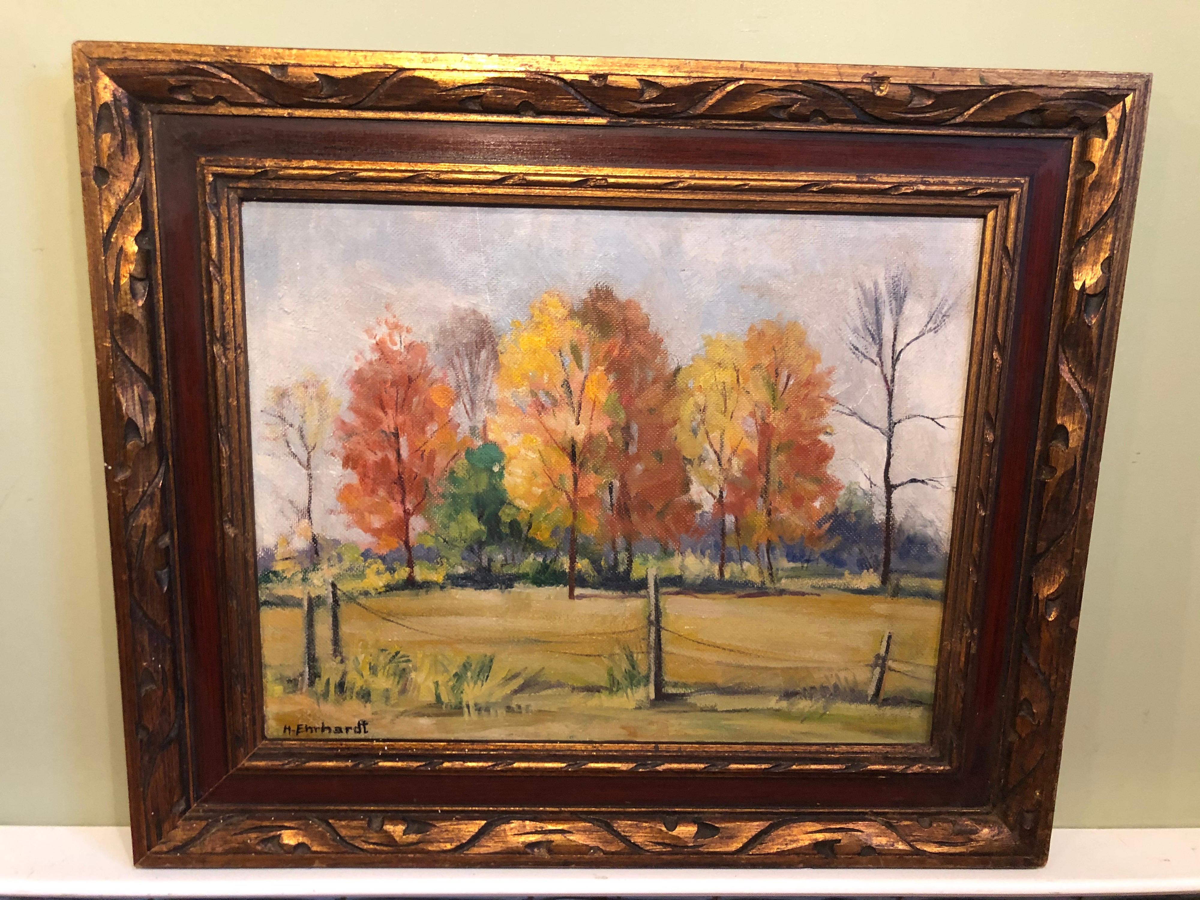 Autumn trees still life oil on board. Signed H. Ernhardt. Nice pastoral fall scene. Inscription says 1940s near Acton school house. Acton, Indiana. Frame is solid wood and hand carved and made in Mexico. This will parcel ship for $45