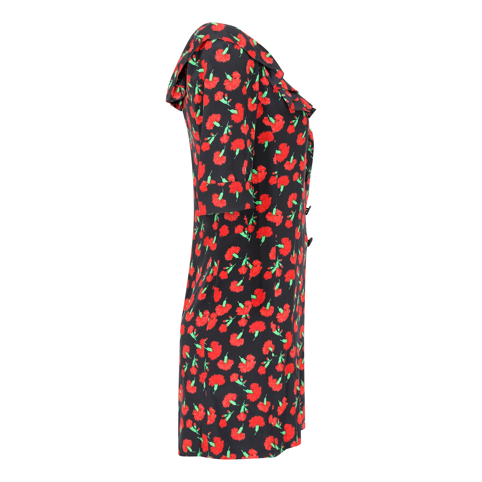 A notable dress from a design icon, Yves Saint Laurent, when he was still at the helm of his eponymous fashion house.  This dress has its origins in the autumn/winter 94 - 95  ready to wear collection where this black and red carnation print was the