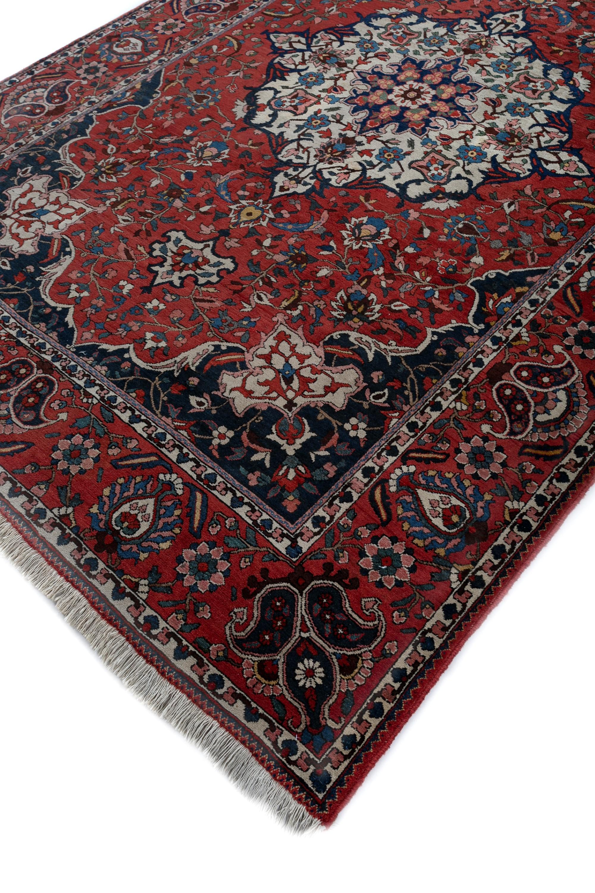 Imagine stepping onto a piece of history, where intricate Persian motifs whisper tales of a bygone era. This handknotted rug, crafted with meticulous care, is a testament to timeless design and traditional artistry. Woven from the finest wool yarns,