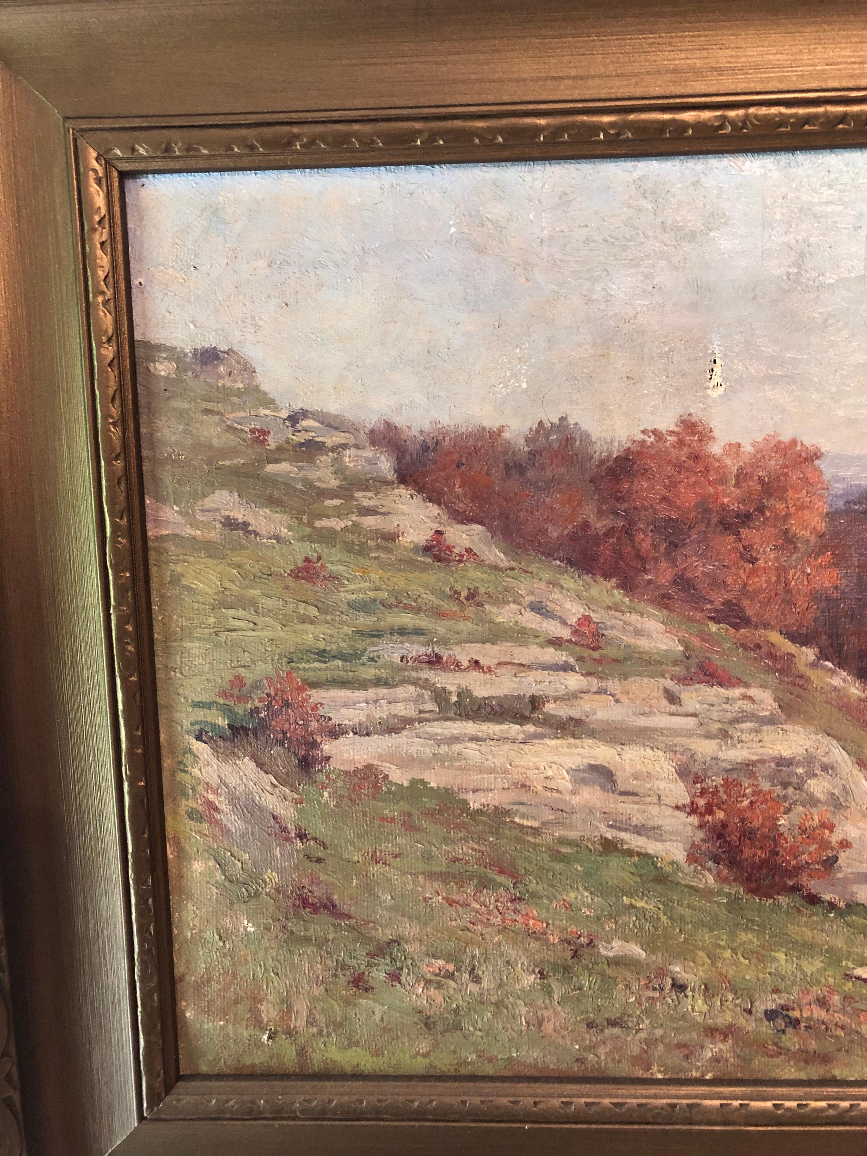 Impressionistic autumnal Massachusetts landscape painting featuring a rocky sloping Hillside with trees in peak foliage set against lavender mountains. Signed lower right margin M.E. Dickinson, 1911. Arts & Crafts gold painted cove moulded frame,