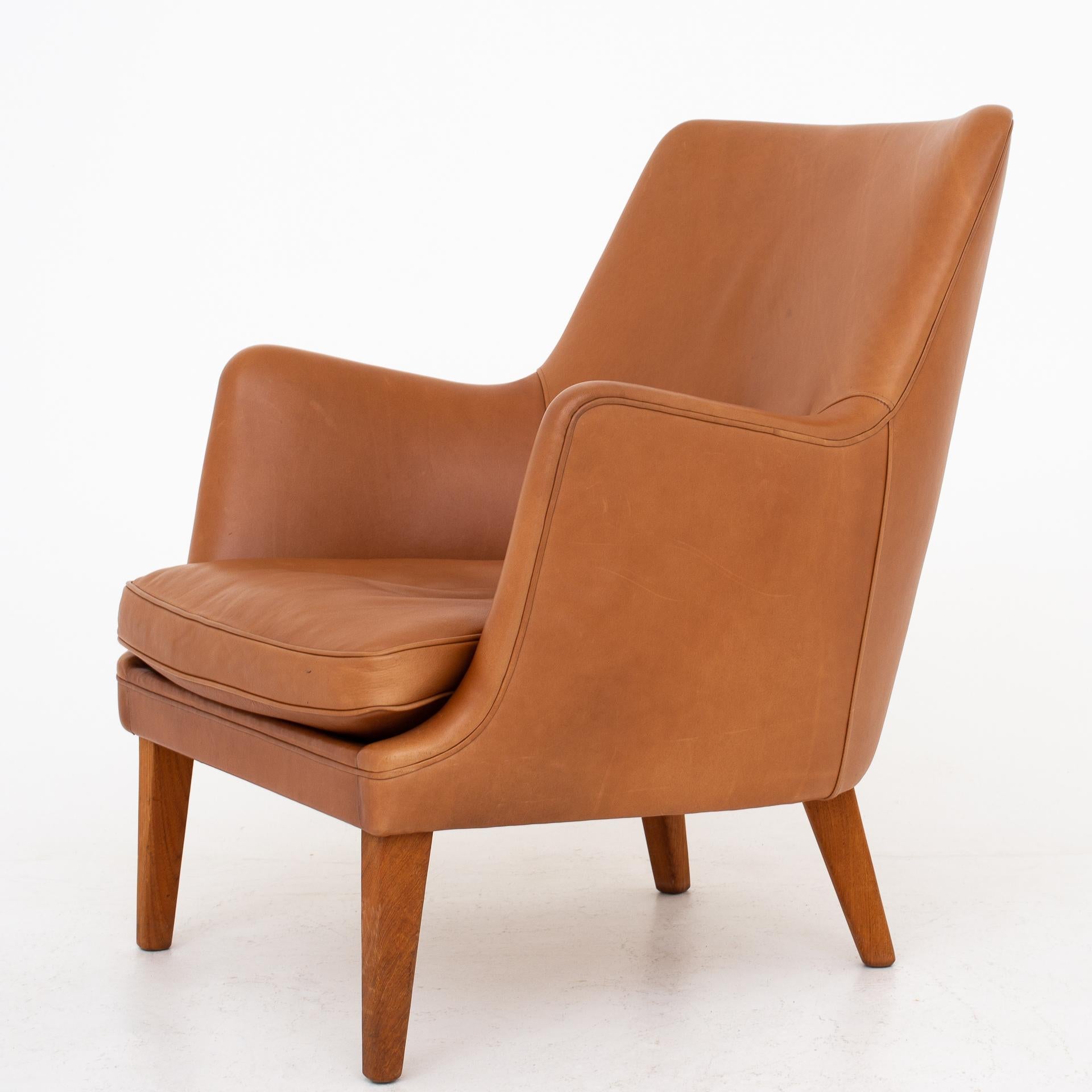 AV 53 set consisting of easy chair and 3-seat sofa. Cognac leather with legs in teak. Maker Ivan Schlechter.